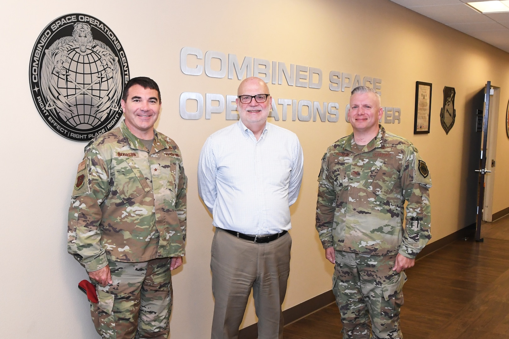 John Roth, performing the duties of the Under Secretary of the Air Force (center), poses for a photo with Brig. Gen. Matthew Davidson, 14th Air Force vice commander (left), and Col. Scott Brodeur, Combined Space Operations Center (CSpOC) director (right), during a visit at Vandenberg AFB, Calif., Aug. 27, 2019