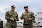 Rear Adm. Tom Anderson (left), commander, Navy Regional Maintenance Center and Naval Sea Systems Command deputy commander, Ship Maintenance and Modernization, receives a brief from Navy Diver Senior Chief Gregory Howe (right), on Ship Repair Facility and Japan Regional Maintenance Center’s diving equipment outside of the dive locker.