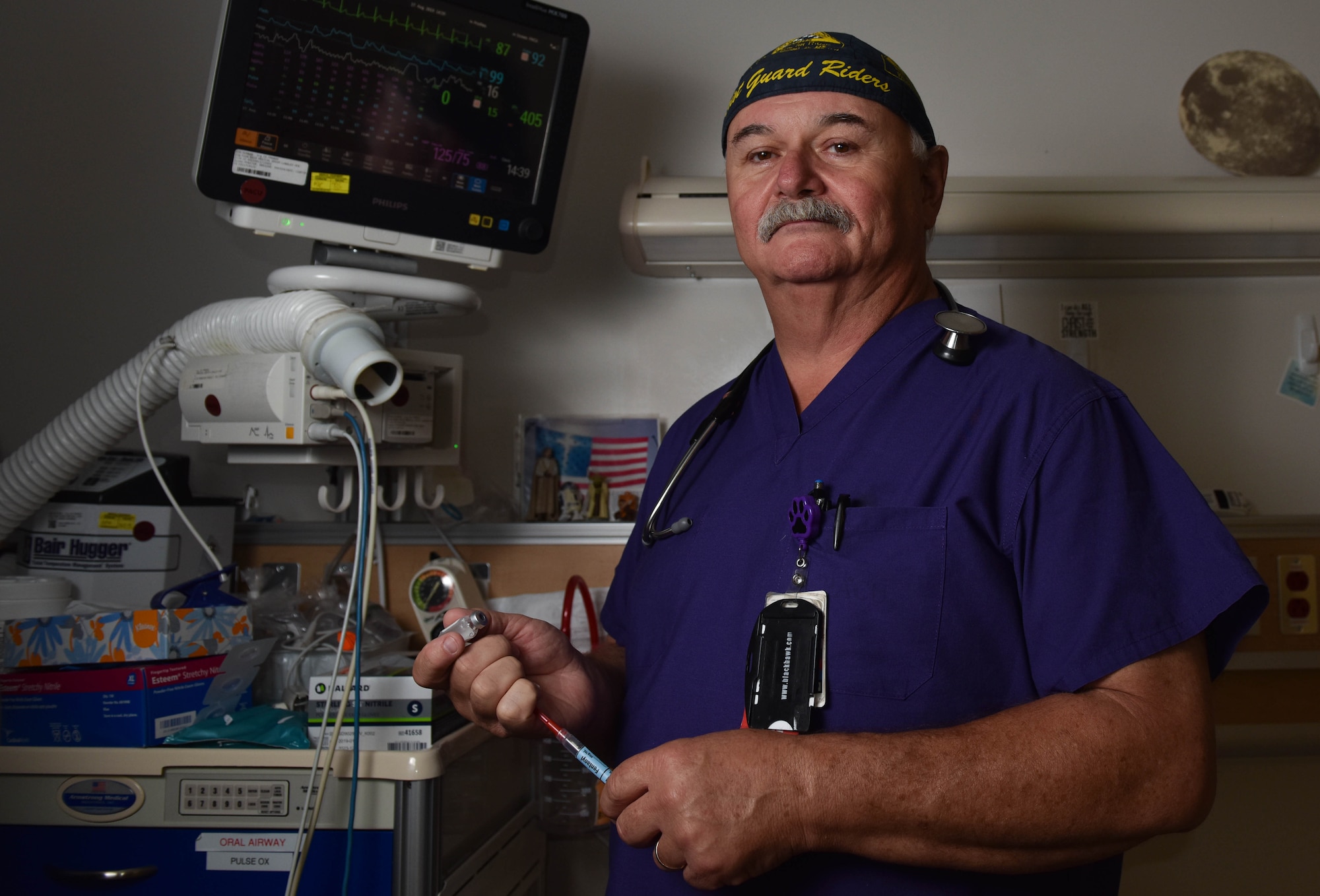 Jeffrey Barbour, 633rd Medical Group same day surgery and post anesthesia unit, monitors a patient's vitals at Joint Base Langley-Eustis, Virginia, Aug. 16, 2019. Barbour’s interest in medical care began when he was very young and joined the Fire Department. (U.S. Air Force photo by Airman 1st Class Sarah Dowe)