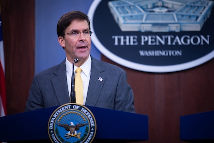 A man speaks at a podium.