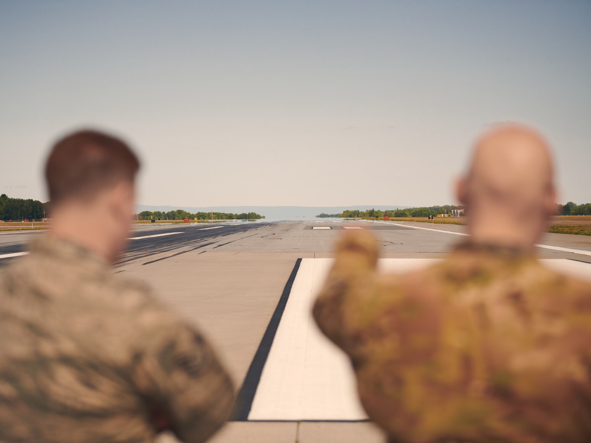 U.S. Air Force Staff Sgt. Joseph Mailloux and Master Sgt. Darren Adams, both assigned to the airfield management section of the 158th Operations Group, 158th Fighter Wing, Vermont Air National Guard, inspect the flightline to ensure it meets all applicable requirements at the Burlington Air National Guard Base, Vt., Aug. 3, 2019. Inspections are done on the flightline daily as a prerequisite to flying, and are done alongside preparations ramping up ahead of F-35 Lightning IIs arriving at a future date. (U.S. Air National Guard photo by Tech. Sgt. Ryan Campbell)