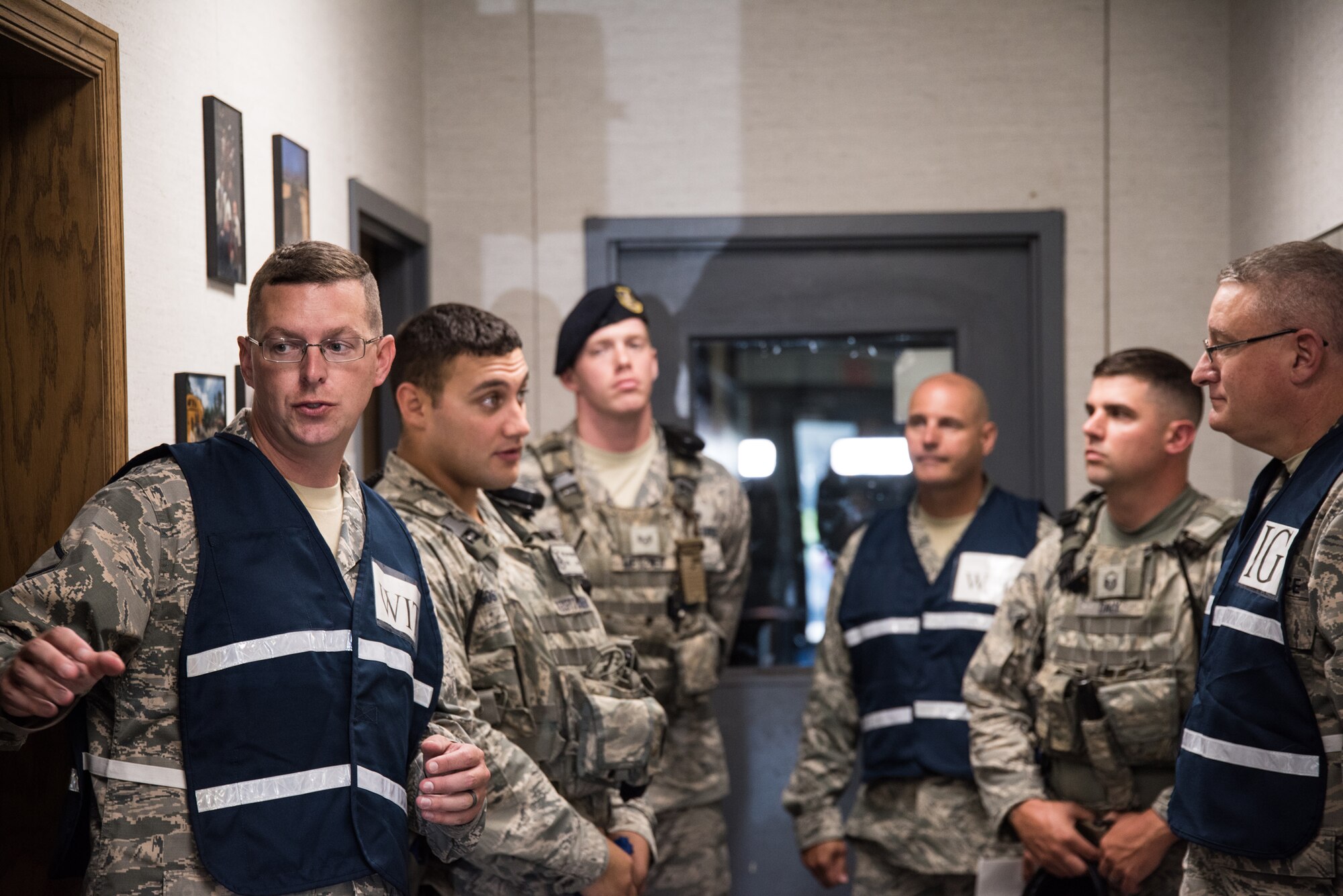 166th Security Forces Airmen gather for an after-action briefing, following an active shooter exercise, at New Castle Air National Guard Base, Aug. 22, 2019. The purpose of this exercise was to provide members of the 166th Airlift Wing with a greater awareness and understanding of possible threats, as well as test their ability to respond properly in the event of an active shooter situation. (U.S. Air National Guard Photo by Mr. Mitchell Topal)
