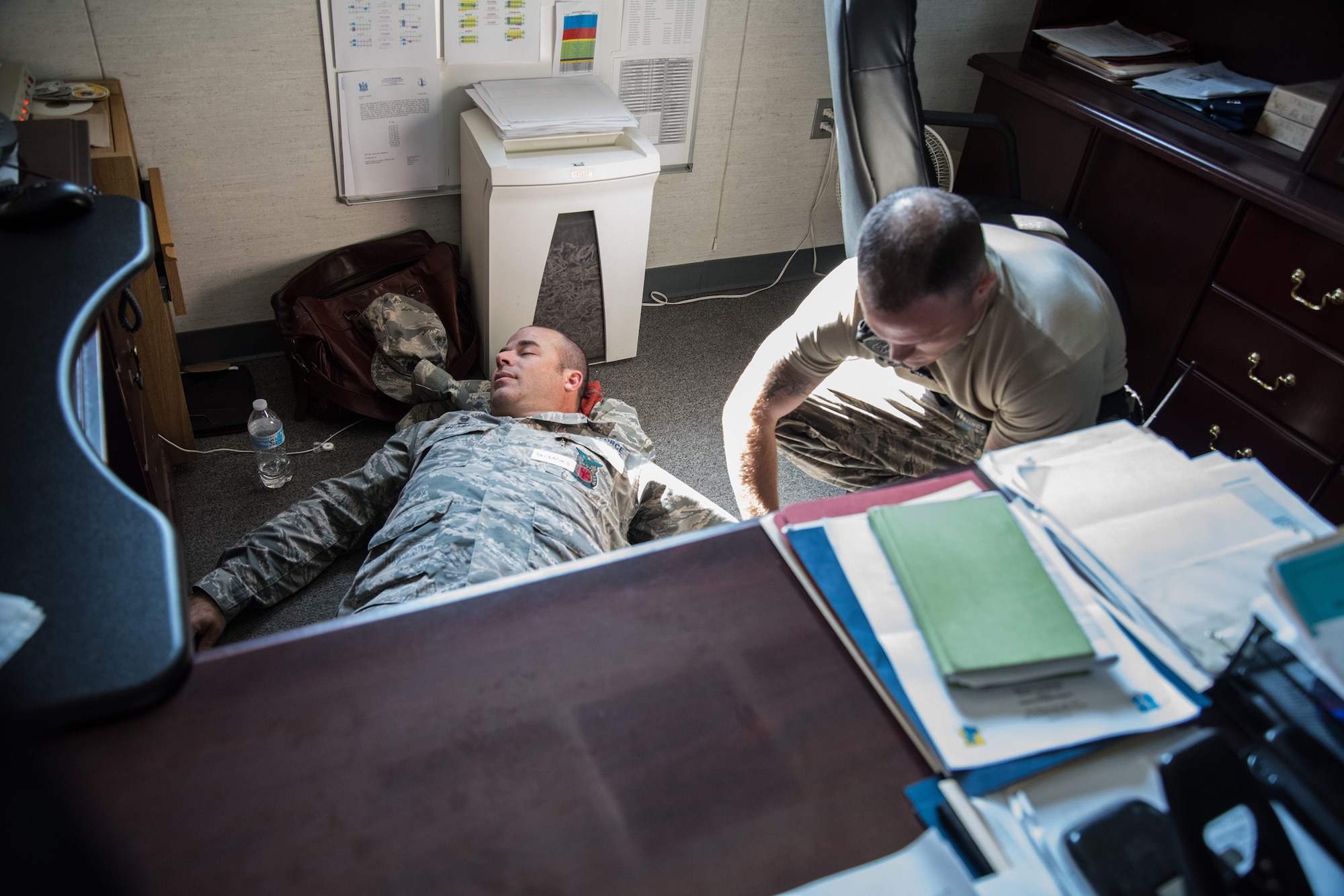 166th Civil Engineer Squadron fire protection specialists, begins triage on Lt. Col. Jeffrey Mertz, 166th Civil Engineer Squadron commander during an active-shooter exercise at New Castle Air National Guard Base, Aug. 22, 2019. Personnel who participated in the exercise were able to take away lessons learned during the scenario, which further prepared them for how to tailor their responses in the event a situation occurs on or off base. (U.S. Air National Guard Photo by Mr. Mitchell Topal)