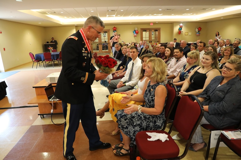 Retired Col. Scott Lowdermilk presents his wife Michelle with a bouquet of roses for her dedicated years of service to both his military and civilian careers, which spanned 38 years. Lowdermilk retired from both federal civil service and the U.S. Army Reserves on Aug. 2, 2019, during a dual-retirement ceremony that took place on the campus of Shenandoah University in Winchester, Virginia, in front of a crowd of more than 250 of his colleagues, peers, family and friends.