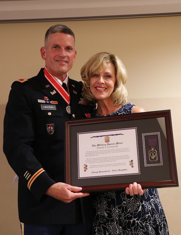 Retired Col. Scott Lowdermilk presents his wife Michelle with The Military Spouse Medal for her dedicated years of service to both his military and civilian careers, which spanned 38 years.