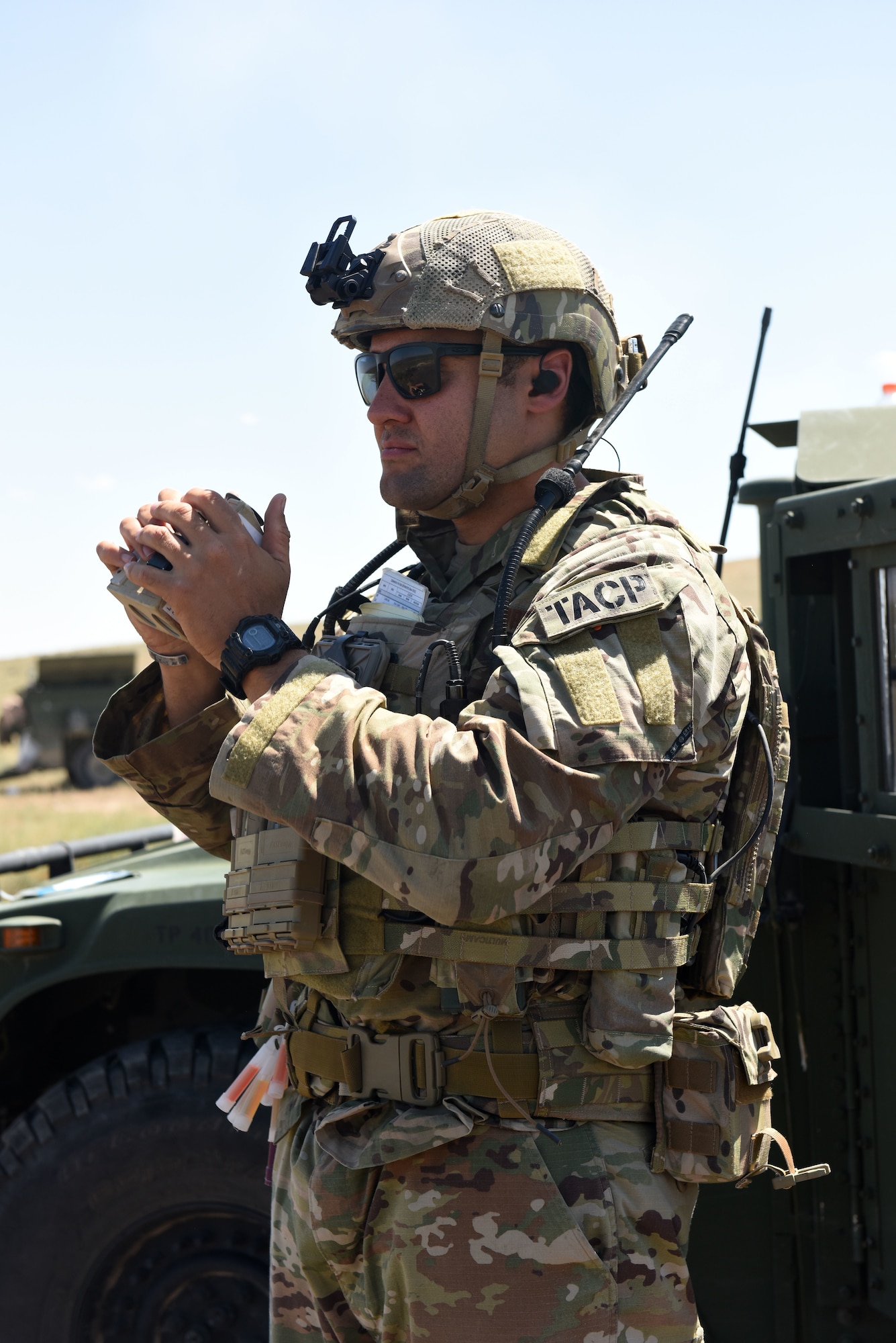 U.S. Air Force Tech. Sgt. Devon Kuny, a Joint Terminal Attack Controller with the 148th Air Support Operations Squadron, uses a laser range finder to help determine distance while coordinating an air strike.