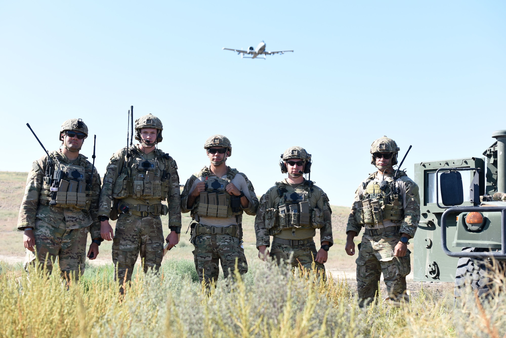 U.S. Air Force Tactical Air Control Party Specialists with the 148th Air Support Operations Squadron anticipate the final pass of an A-10 after they called in the aircraft to do a simulated air strike Aug. 13, 2019.