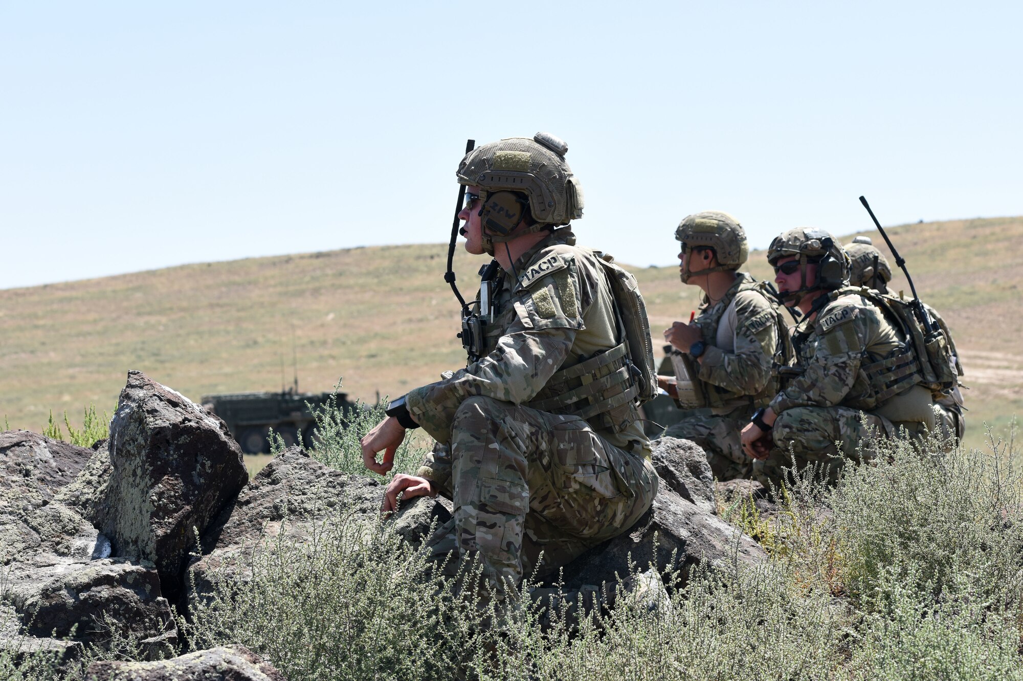 Tactical Air Control Party Specialists with the 148th Air Support Operations Squadron keep their eyes on the target as they wait for the A-10 air support they called in to drop simulated munitions on a target Aug. 13, 2019.
