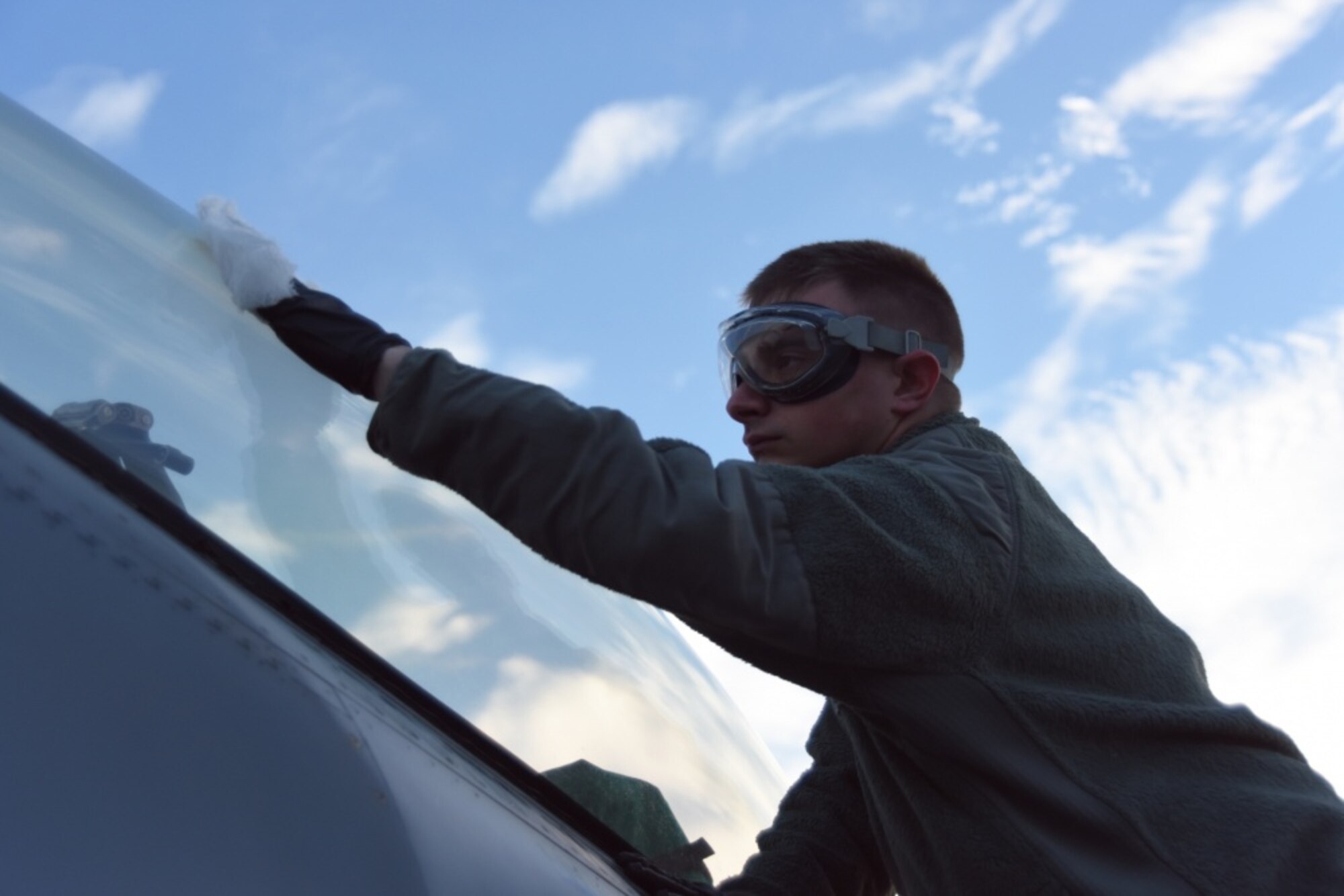Staff Sgt. Brian Dement, a crew chief assigned to the 180th Fighter Wing, Ohio Air National Guard, polishes the canopy of an F-16 Fighting Falcon before early morning training sorties at Patrick Air Force Base, Florida, Jan. 30, 2019. As part of the Patrick AFB deployment, the 180FW conducted Dissimilar Air Combat Training, Basic Fighter Maneuvers, Defensive Air Counter Tactics and Tactical Intercept missions alongside F-15 Eagles assigned to the 104th Fighter Wing, Barnes Air National Guard Base, Massachusetts. (Air National Guard photo by Senior Airman Hope Geiger)