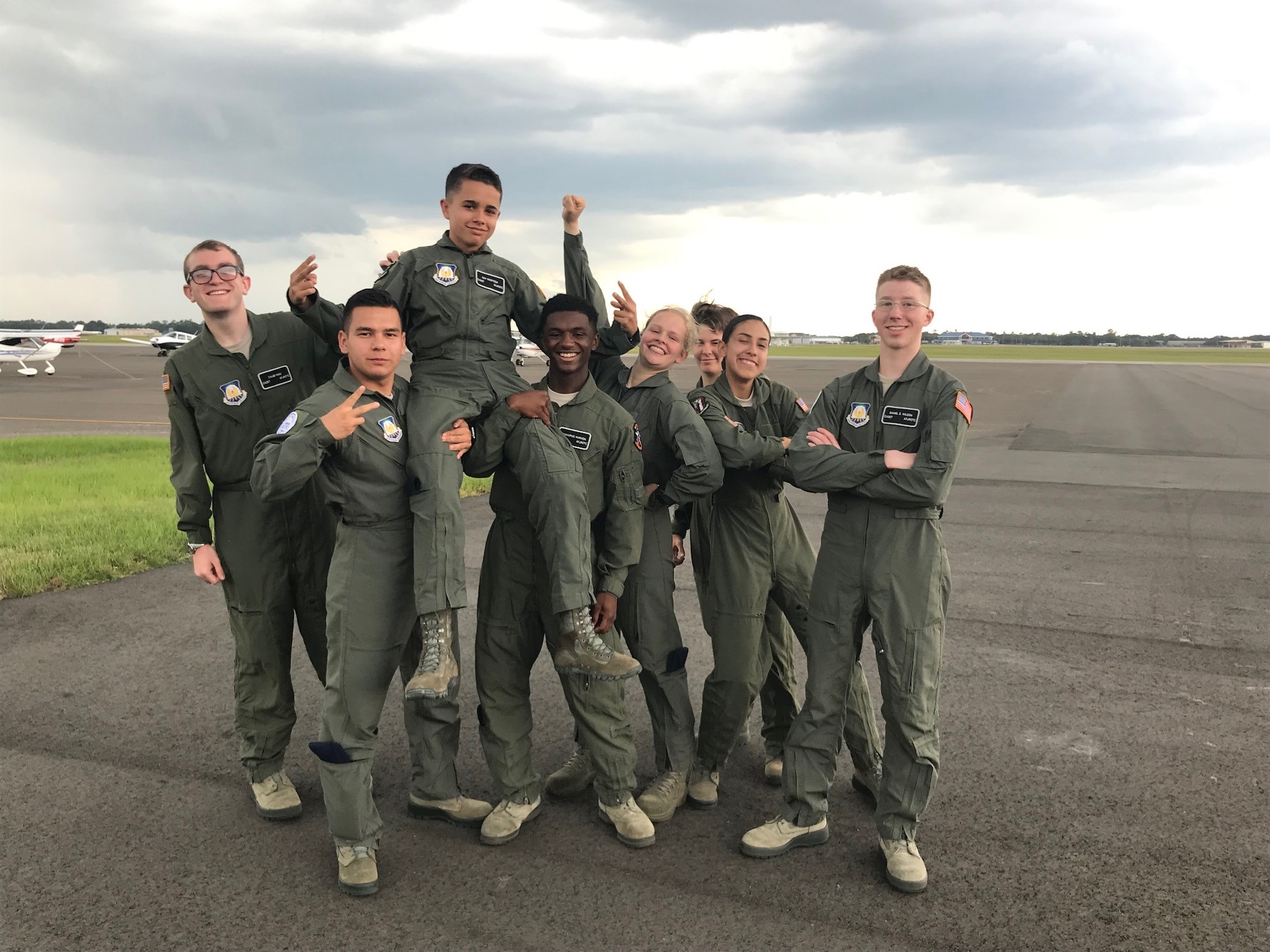 Air Force Junior ROTC cadets at Southeastern University, Lakeland, Florida, participating in the Air Force JROTC Flight Academy take a moment on the flightline to celebrate their accomplishments.  The Flight Academy is a Chief of Staff of the Air Force Scholarship Program intended to expose high school students to the benefits of a career in aviation.  The scholarship covers transportation, room and board, academics and flight hours required to potentially earn a private pilot certification.