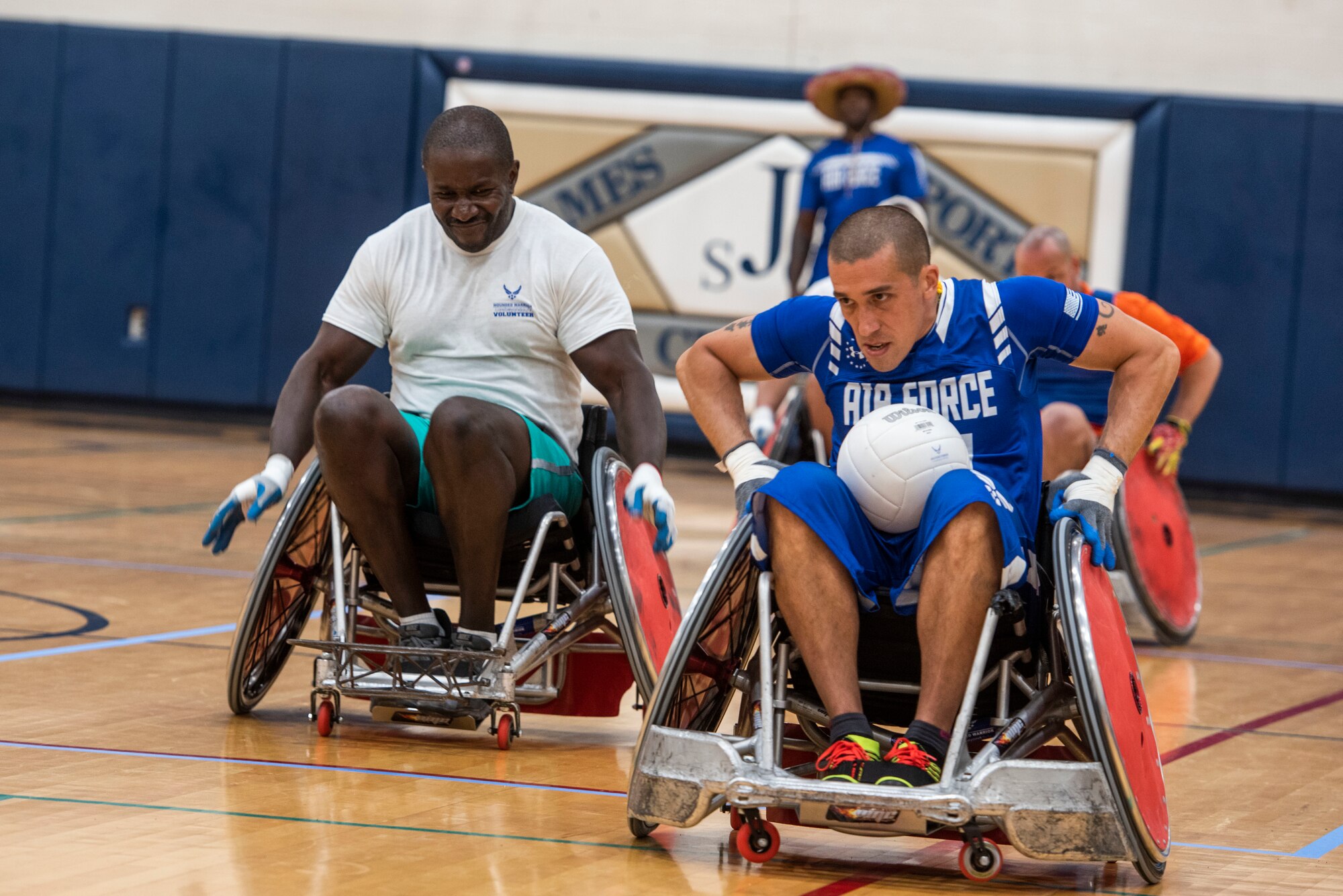 Master Sgt. Quinn Harrington, Air Force Wounded Warrior, races down the court during a wheelchair rugby game for the Air Force Wounded Warrior CARE event, Aug. 23, 2019 at Scott Air Force Base, Ill. During the week, Harrington also competed in sitting volleyball and field events. (U.S. Air Force photo by Senior Airman Daniel Garcia)