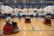 Air Force Wounded Warriors play a game of wheelchair rugby against volunteers during the AFW2 CARE event, Aug. 23, 2019 at Scott Air Force Base, Ill. Throughout the week, program participants and volunteers were given time to learn the rules of the game, practice and get comfortable with racing up and down the court in wheelchairs. (U.S. Air Force photo by Senior Airman Daniel Garcia)