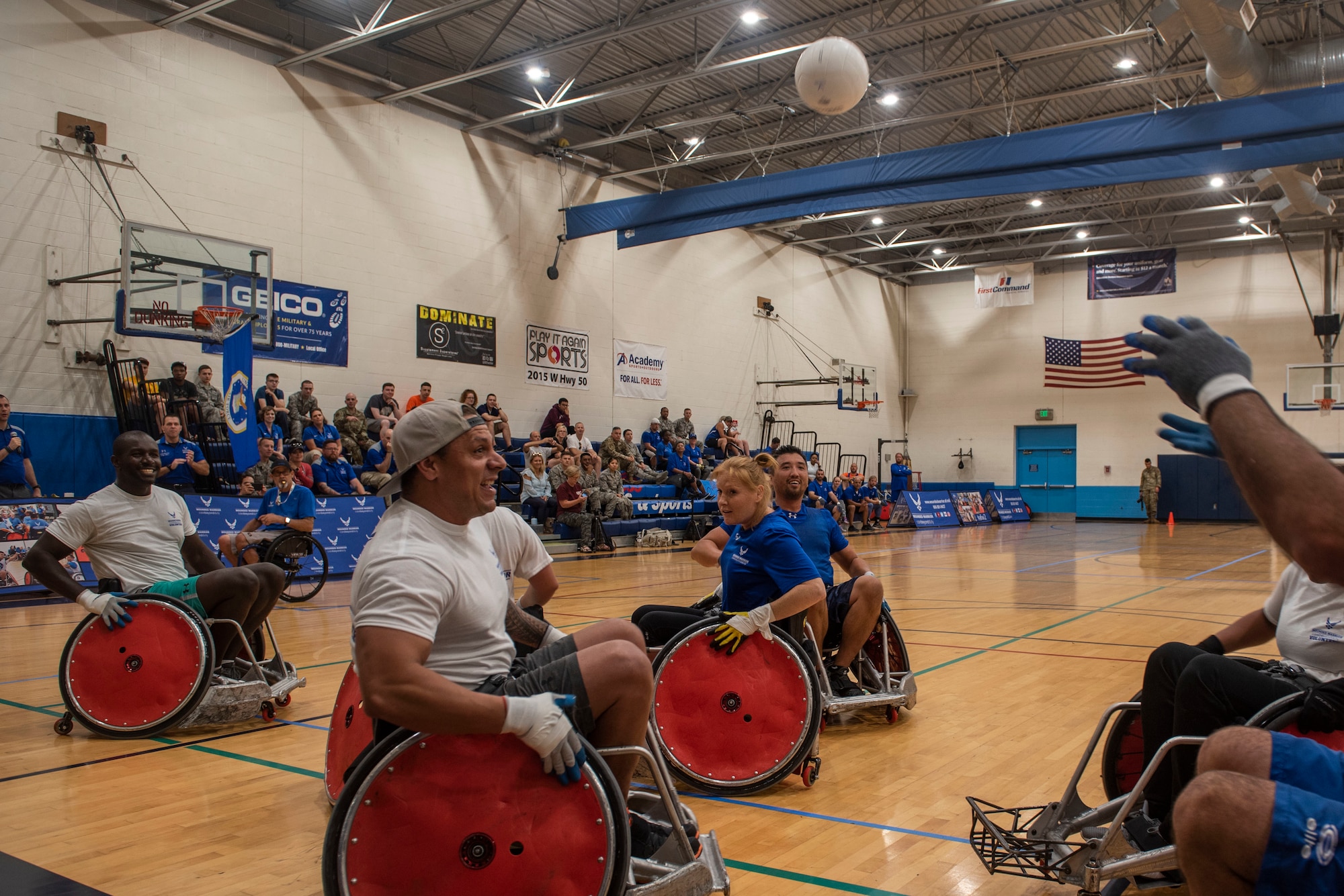 Air Force Wounded Warriors play a game of wheelchair rugby against volunteers, during the AFW2 CARE event Aug. 23, 2019 at Scott Air Force Base, Ill. Throughout the week, program participants and volunteers were given time to learn the rules of the game, practice and get comfortable with racing up and down the court in wheelchairs. (U.S. Air Force photo by Senior Airman Daniel Garcia)