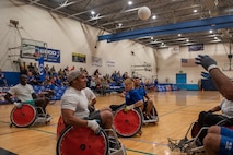 Air Force Wounded Warriors play a game of wheelchair rugby against volunteers, during the AFW2 CARE event Aug. 23, 2019 at Scott Air Force Base, Ill. Throughout the week, program participants and volunteers were given time to learn the rules of the game, practice and get comfortable with racing up and down the court in wheelchairs. (U.S. Air Force photo by Senior Airman Daniel Garcia)