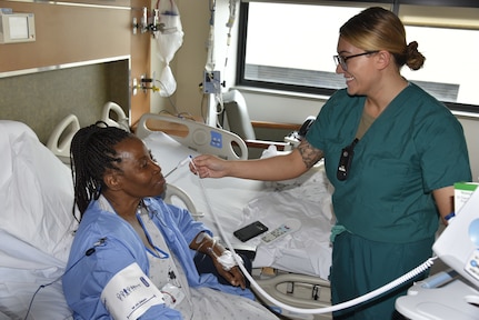 Army 1st Lt. Gabrielle Williams, a nurse in 4-West, cares for a patient at Walter Reed National Military Medical Center in Bethesda, Maryland.