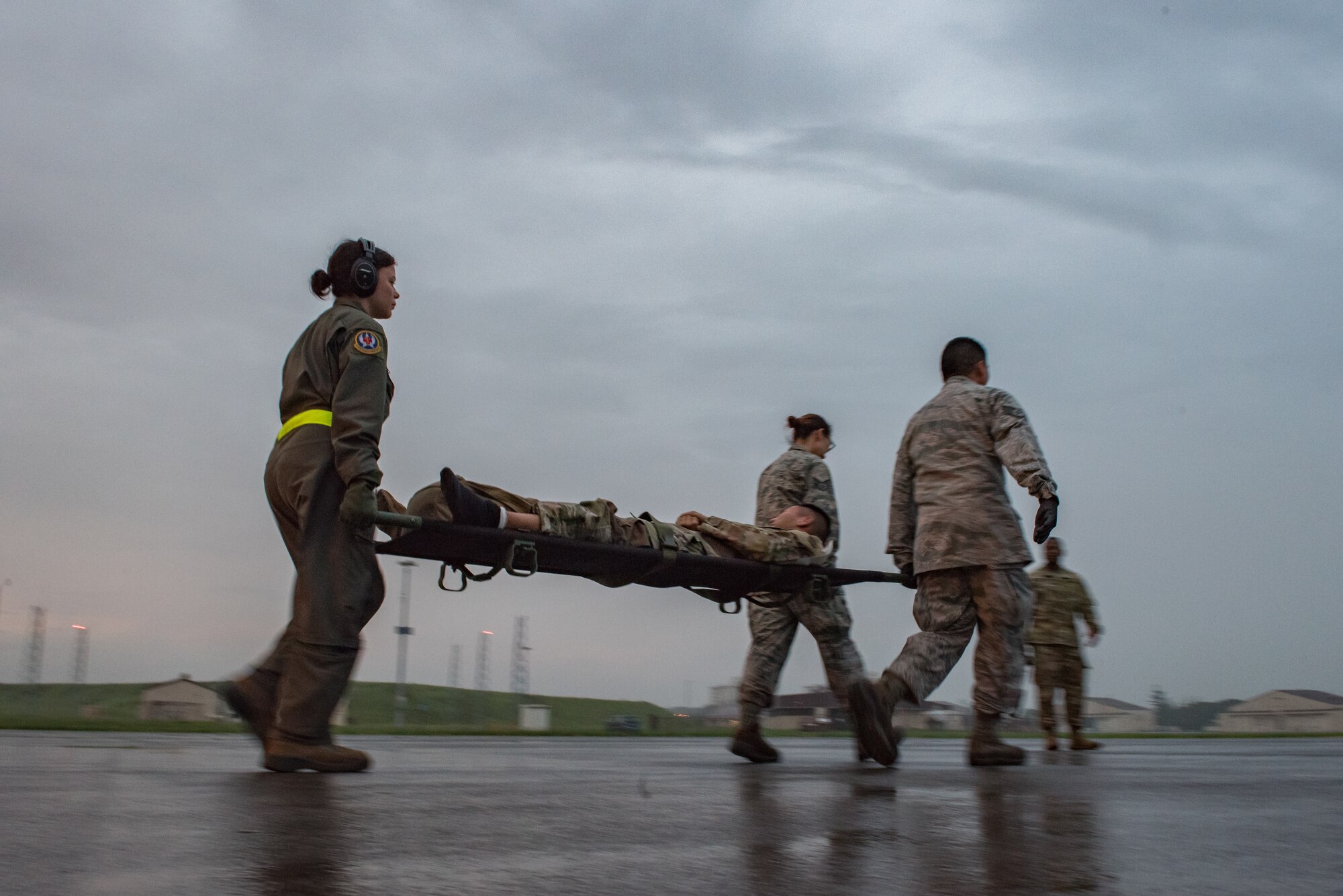 U.S. Air Force personnel assigned to the 374th Medical Group, Yokota Air Base, Japan carry simulated patients out of a C-130J Super Hercules, Aug. 28, 2019. They moved and treated more than 30 U.S. Army personnel off the aircraft as part of Operation Ascendant Eagle, a joint patient movement exercise held between Osan Air Base, Korea and Yokota. (U.S. Air Force photo by Staff Sgt. Kyle Johnson)