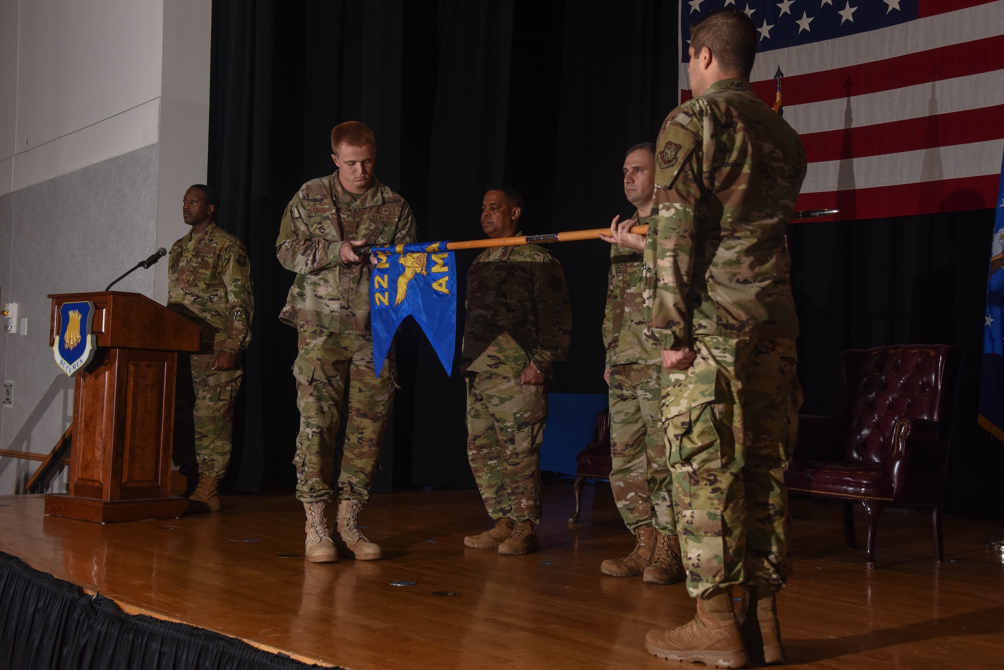 Senior Airman Alexander Cavender, 22nd Operational Medical Readiness Squadron bioenvironmental technician, furls the 22nd Aerospace Medicine Squadron guidon during a redesignation ceremony Aug. 29, 2019, at McConnell Air Force Base, Kan. The 22nd AMDS was redesignated to the 22nd OMRS respectively after 24 years. (U.S. Air Force photo by Airman 1st Class Marc A. Garcia)