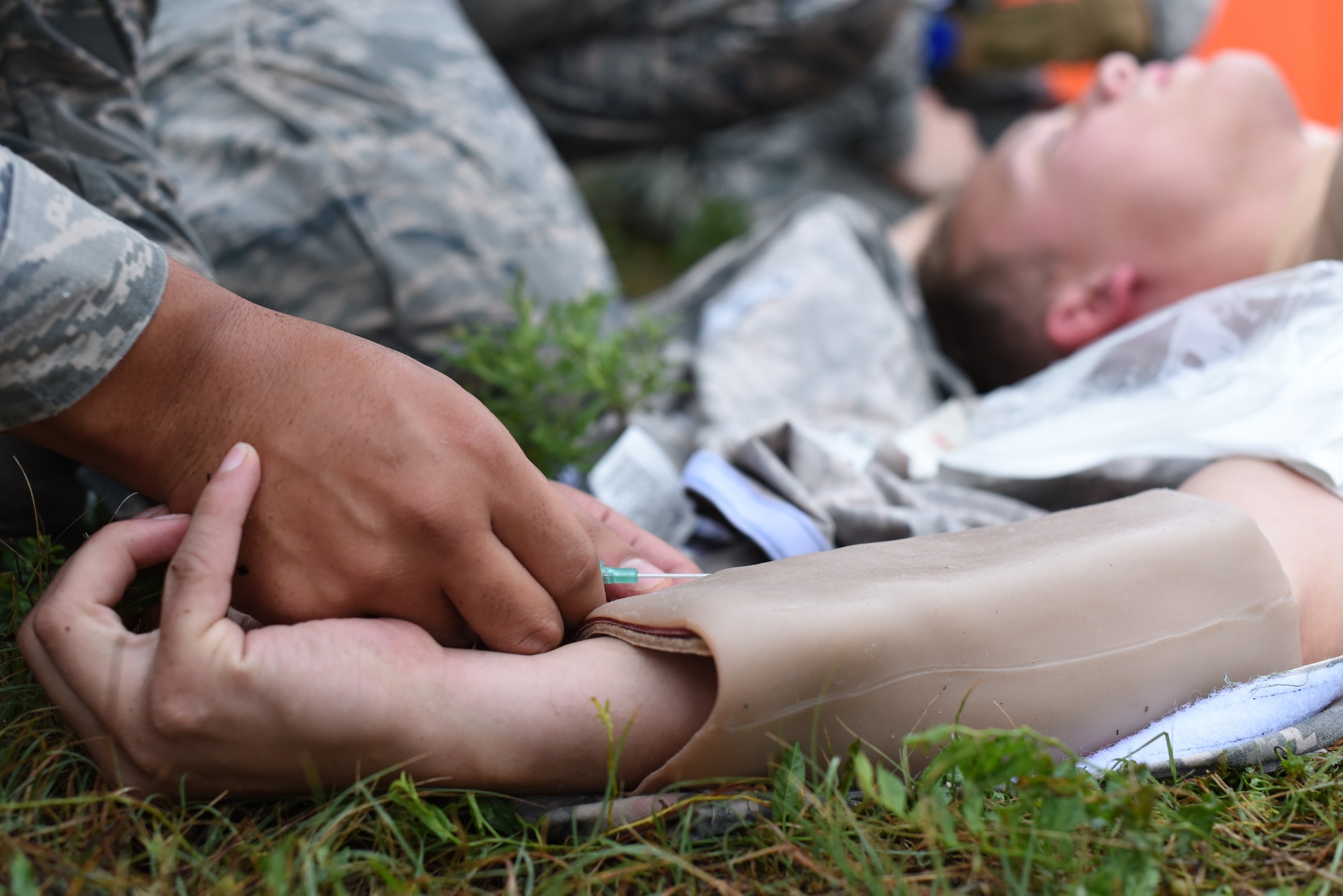 Airman 1st Class Anthony Thomason 22nd Healthcare Operation Squadron medical technician, uses Tactical Combat Casualty Care techniques during an Emergency Medical Technician Rodeo Aug. 22, 2019, at McConnell Air Force Base, Kan. TCCC is a standardized course created to give Airmen the tools that they need to survive using lifesaving medical training while in a combat environment. TCCC will replace the Self Aid and Buddy Care Program and will be focus on controlling massive bleeding, care under fire and airway management. (U.S. Air Force photo by Airman 1st Class Alexi Myrick)