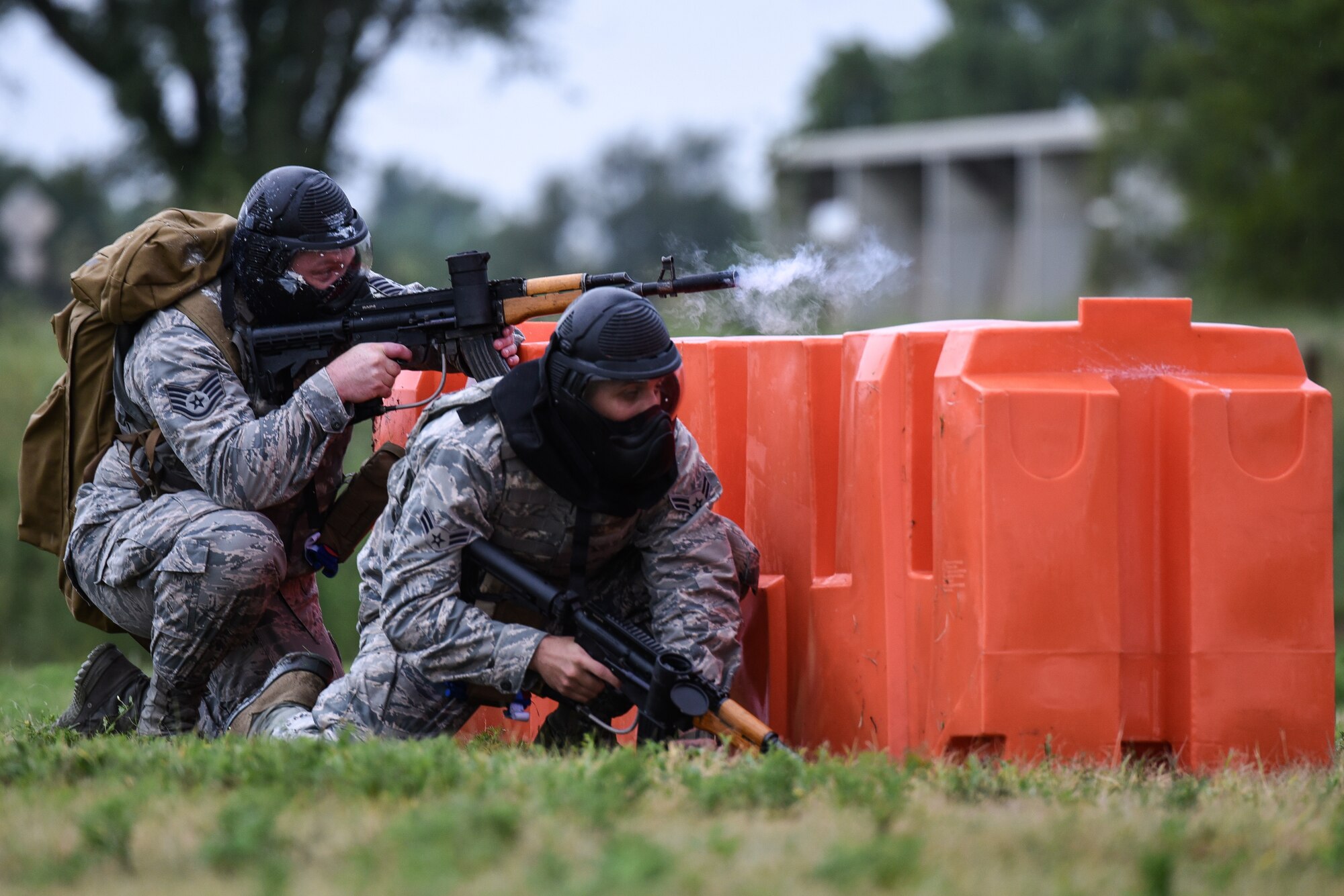 Staff Sgt. Aaron Wooton, 22nd Aerospace Medicine Squadron operational medical technician, and Airman 1st Class Ruben Toledo-Bravo 22nd Medicine Support Squadron health services management apprentice, participate in an Emergency Medical Technician Rodeo Aug. 22, 2019, at McConnell Air Force Base, Kan. The rodeo consisted of medical technicians armed with paintball guns enduring a simulated combat scenario while trying to identify and perform combat care tactics. (U.S. Air Force photo by Airman 1st Class Alexi Myrick)