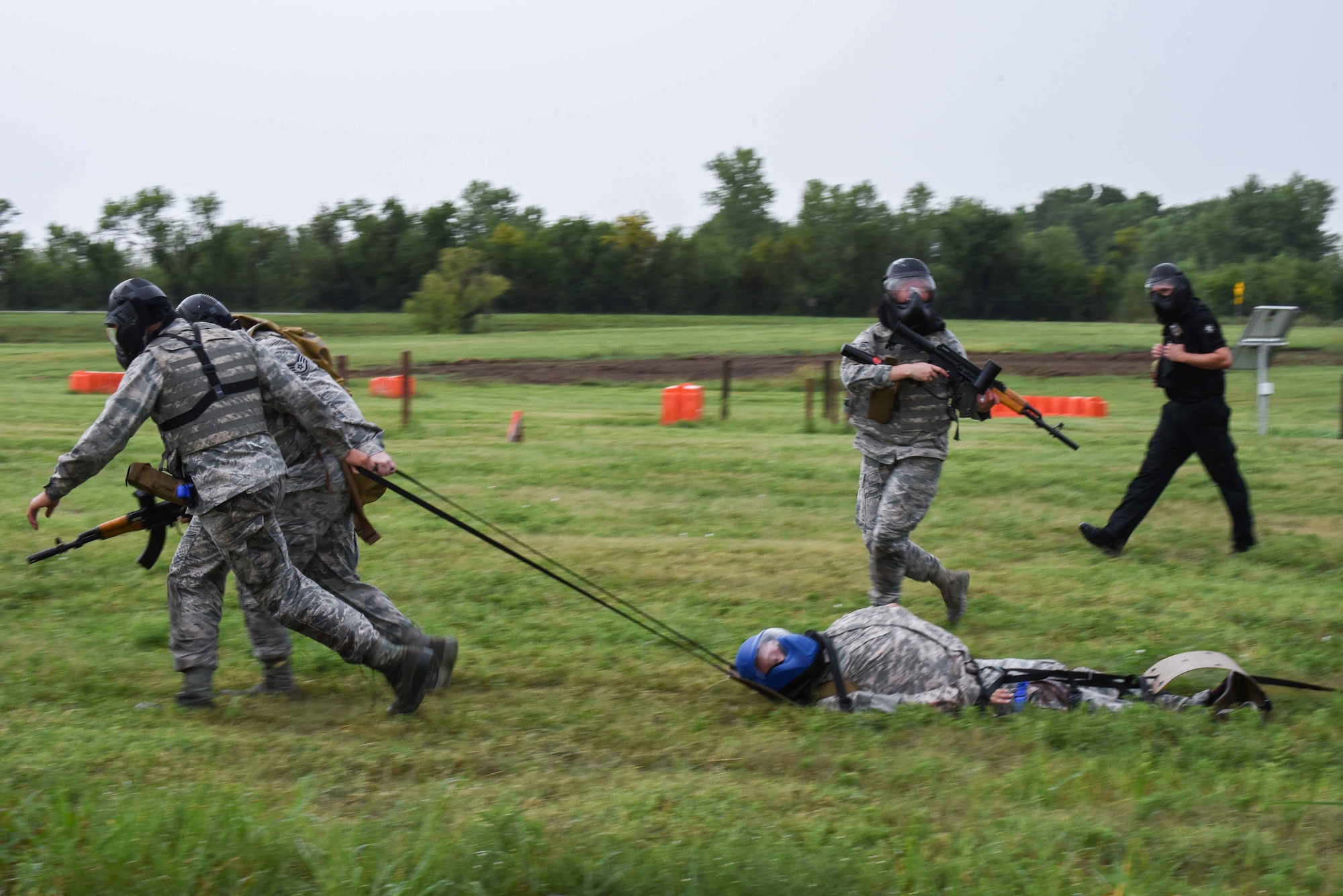 Staff Sgt. Aaron Wooton, 22nd Aerospace Medicine Squadron operational medical technician, and Airman 1st Class Anthony Thomason 22nd Healthcare Operation Squadron medical technician, drag Airman 1st Class Dylan Nealy 22nd HCOS health services management apprentice, to safety during an Emergency Medical Technician Rodeo Aug. 22, 2019, at McConnell Air Force Base, Kan. The medics practiced Tactical Combat Casualty Care tactics to effectively recover the Airman and stabilize his simulated injuries. (U.S. Air Force photo by Airman 1st Class Alexi Myrick)