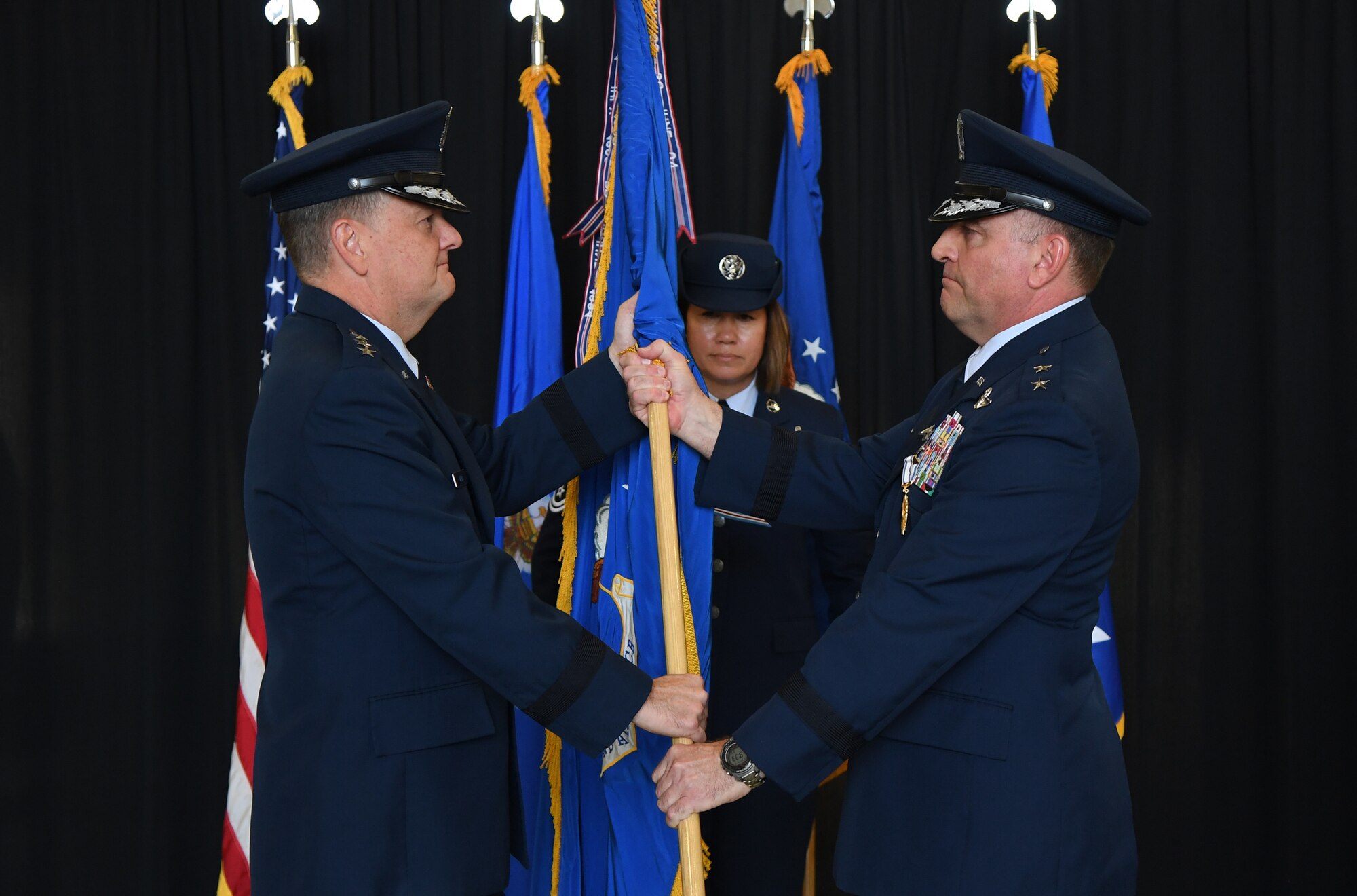 U.S. Air Force Lt. Gen. Brad Webb, commander of Air Education and Training Command, takes the guidon from Maj. Gen. Timothy Leahy, Second Air Force commander, during the Second Air Force change of command ceremony on Keesler Air Force Base, Mississippi, Aug. 29, 2019. The ceremony is a symbol of command being exchanged from one commander to the next. Leahy relinquished command of the Second Air Force to Maj. Gen. Andrea Tullos. (U.S. Air Force photo by Kemberly Groue)