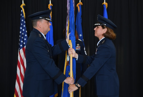 U.S. Air Force Lt. Gen. Brad Webb, commander of Air Education and Training Command, passes the guidon to Maj. Gen. Andrea Tullos, Second Air Force commander, during the Second Air Force change of command ceremony on Keesler Air Force Base, Mississippi, Aug. 29, 2019. The ceremony is a symbol of command being exchanged from one commander to the next. Tullos assumed command of the Second Air Force from Maj. Gen. Timothy Leahy. (U.S. Air Force photo by Kemberly Groue)
