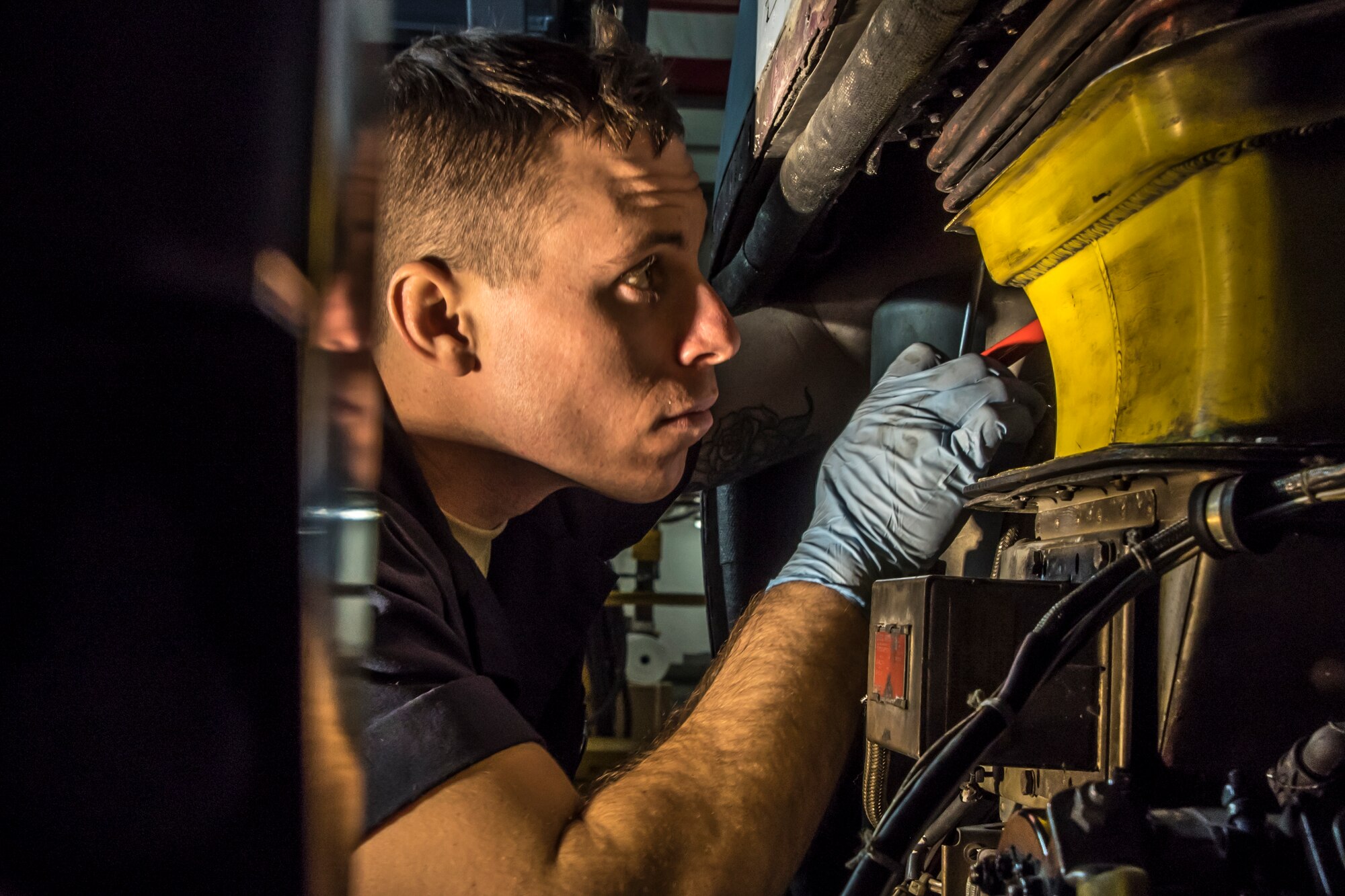 A photo of a military member working an a C-130 aircraft.