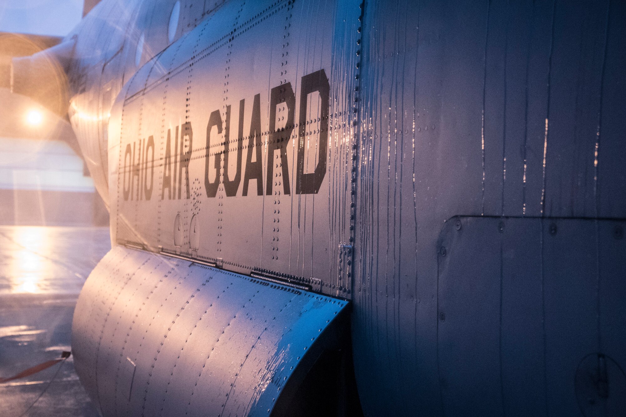A photo of sun reflecting off the side of a C-130 that says Ohio Air Guard.