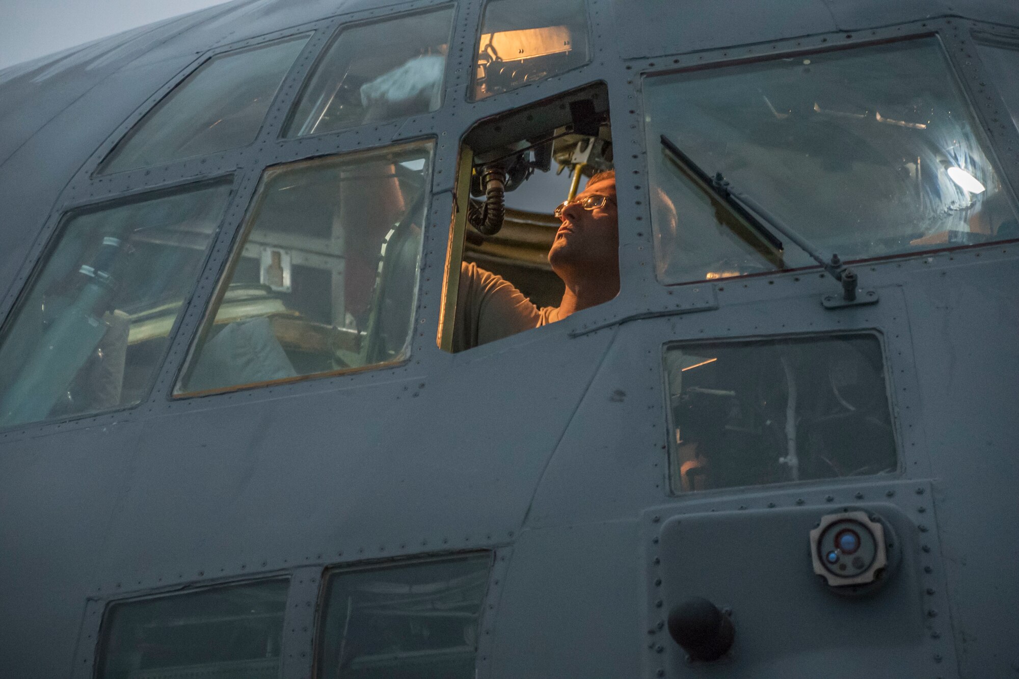 A photo of a military member through the C-130 windows