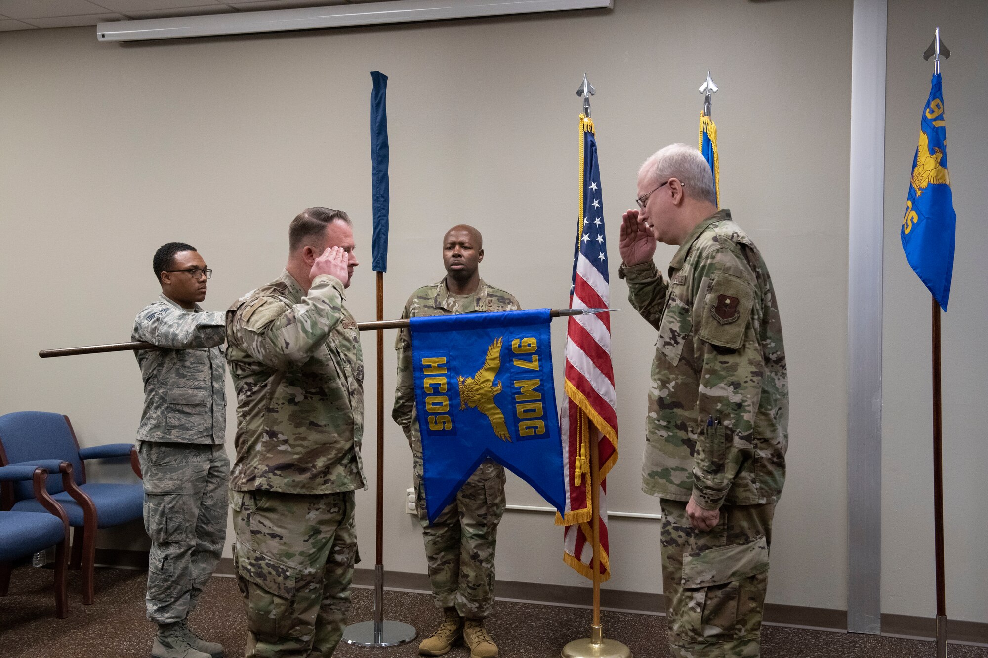 97th Healthcare Operations Squadron commander, salutes Col. Howard Givens, 97th Medical Group commander,