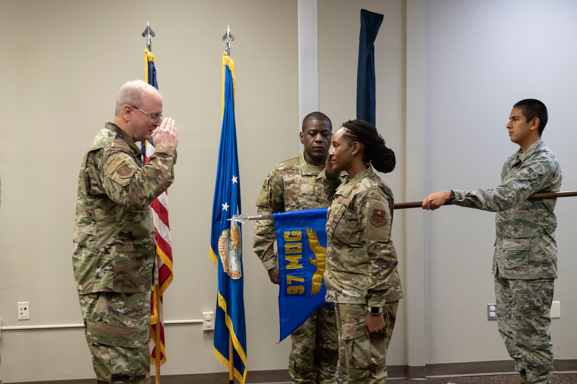 U.S. Air Force Lt. Col. Angela Manning, 97th Operational Medical Readiness Squadron commander, salutes Col. Howard Givens, 97th Medical Group commander,