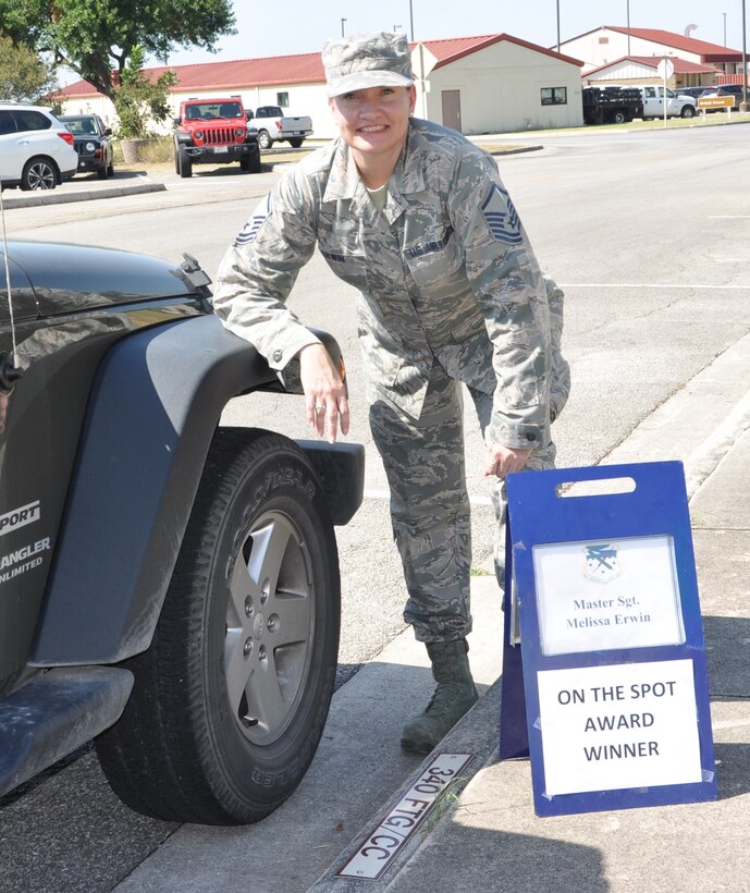 Master Sgt. Melissa Erwin, 340th Flying Training Group information technology superintendent, stakes her claim to the commander's parking spot following selection as the 340th FTG August On-the-Spot Award winner. Nicely Done Melissa! (U.S. Air Force photo by Janis El Shabazz)