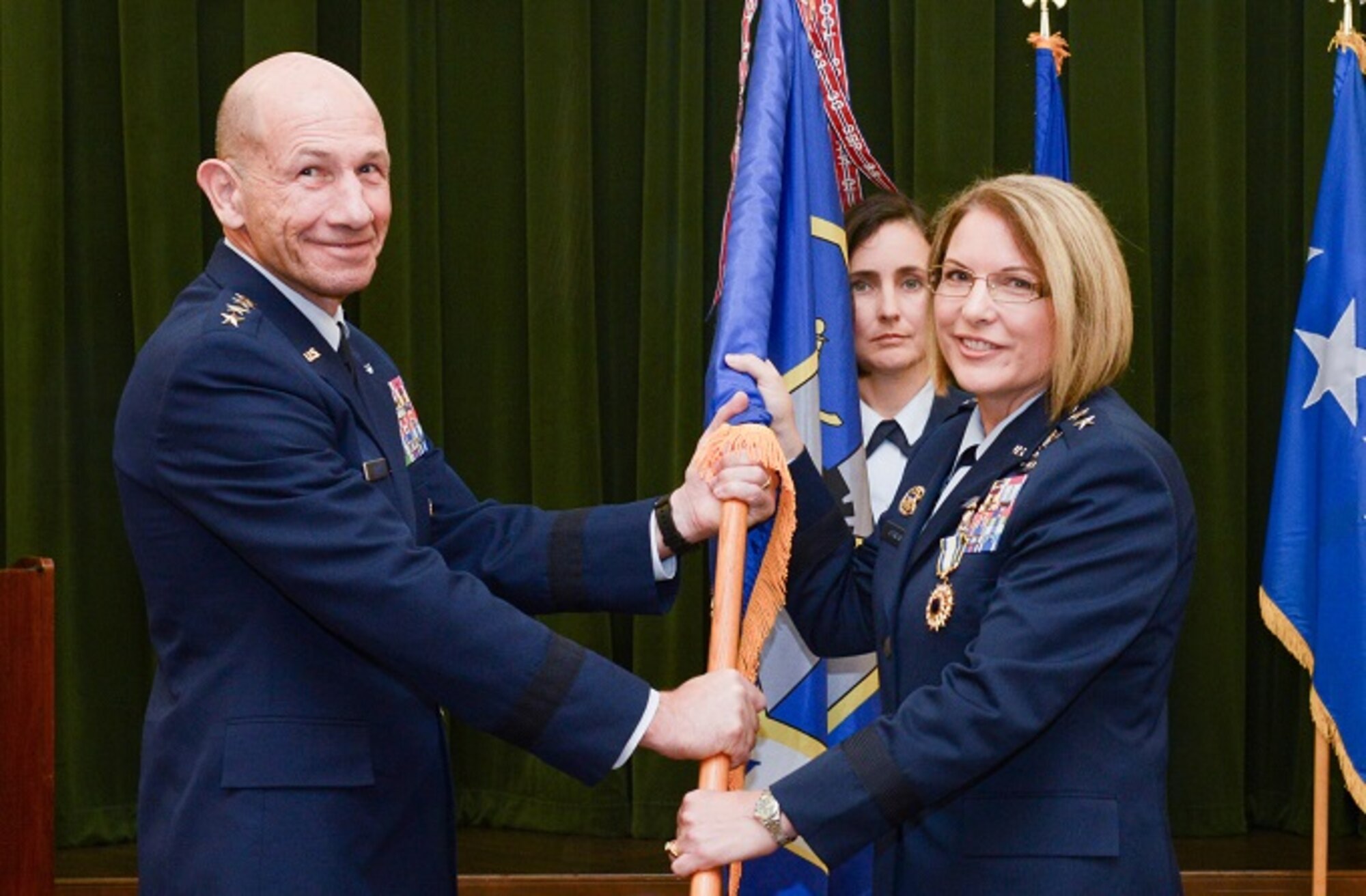 U.S. Air Force Gen. Mike Holmes, Air Combat Command commander, relieves Maj. Gen. Mary F. O’Brien of command during the Twenty-Fifth Air Force change of command ceremony