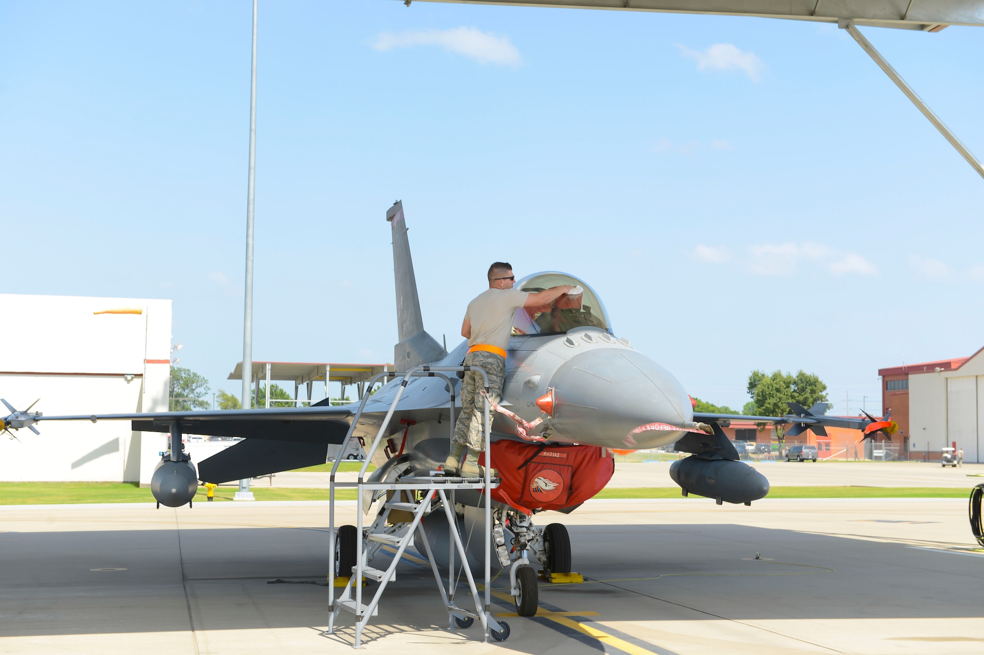 Staff Sgt. Cody Brown, 138th Maintenance Squadron, polishes the canopy of an F-16 fighter jet as part of the post-flight procedures on July 13, 2016 at the 138th Fighter Wing. The wraparound canopy provides ideal light in-flight and can withstand the impact of a 4 pound bird at 550 knots. (Air National Guard photo/Master Sgt. Roberta A. Thompson)