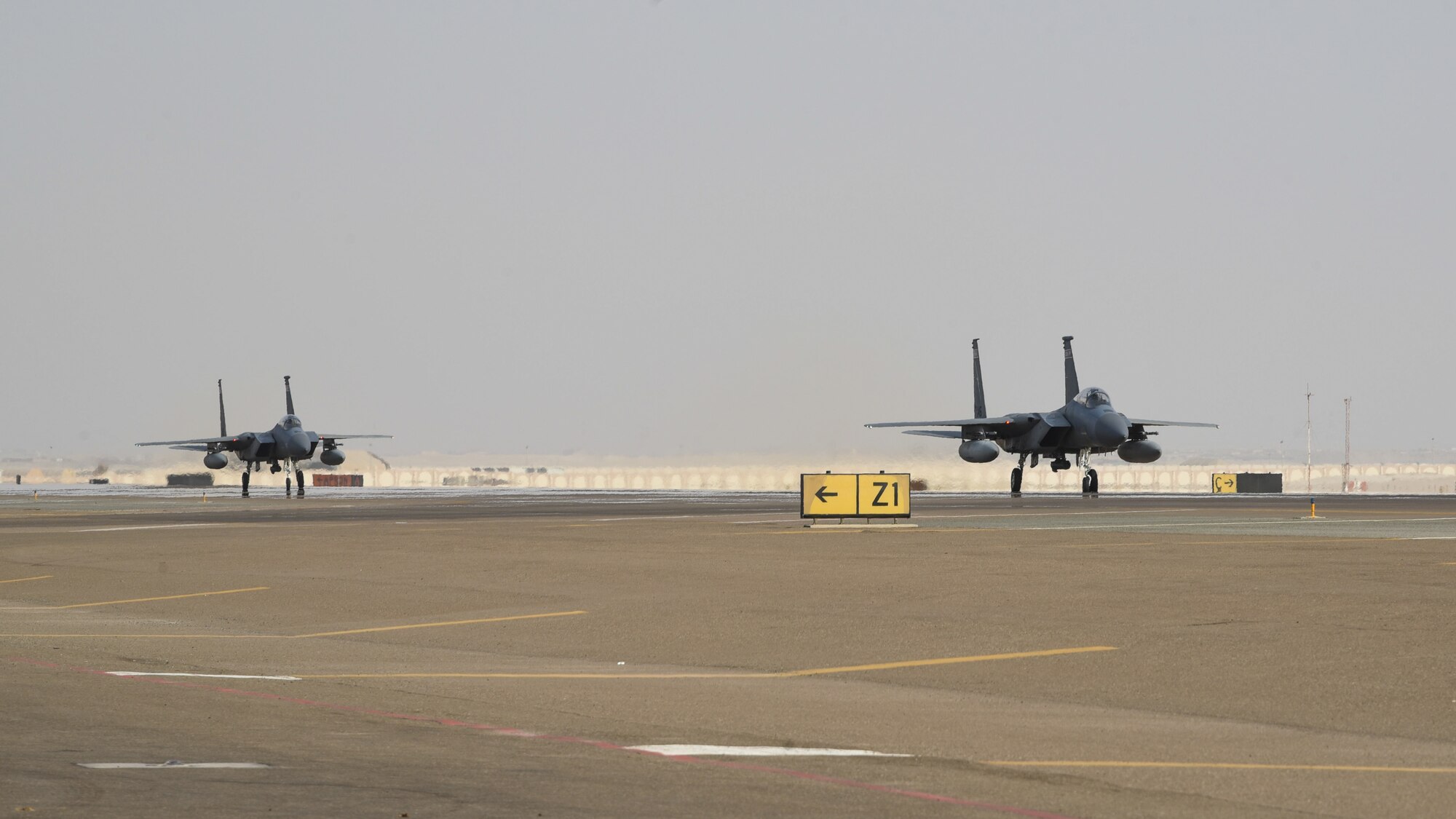 Two F-15C Eagles taxi after exercise Hype Eagle Aug. 18, 2019, at Al Dhafra Air Base, United Arab Emirates. The 159th Expeditionary Fighter Squadron forward deployed to Prince Sultan Air Base, Saudi Arabia to challenge their flexibility at expanding tactical and strategical reach while strengthening coalition and regional partnerships in the U.S. Central Command area of responsibility. (U.S. Air Force photo by Tech. Sgt. Jocelyn Ford)