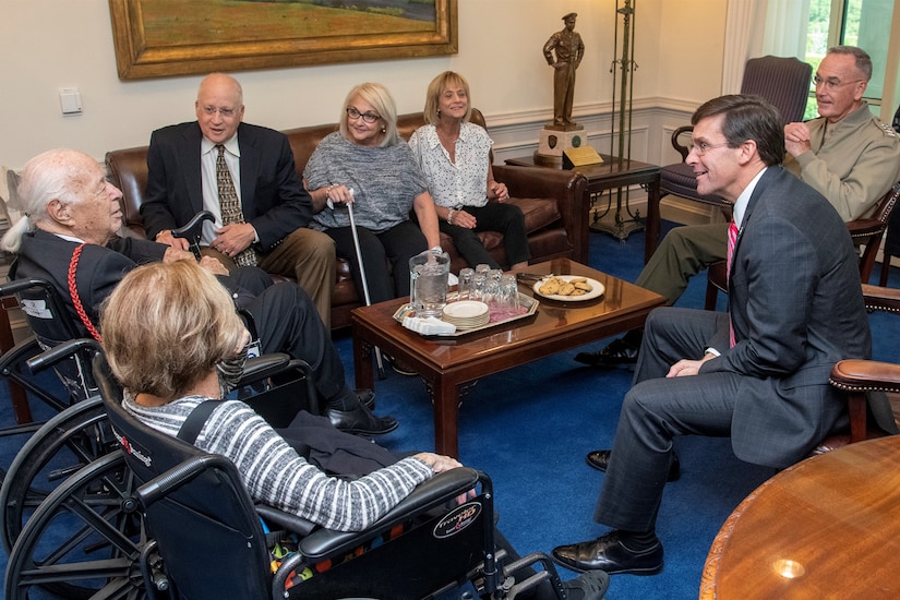 People meet in a room in the Pentagon.