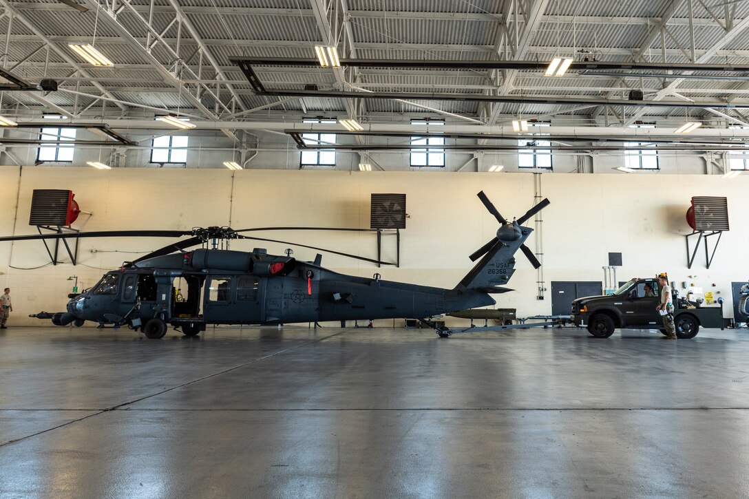 Airmen assigned to the 723d Aircraft Maintenance Squadron tow an HH-60G Pave Hawk into a hangar Aug. 30, 2019, at Moody Air Force Base, Ga. All Moody aircraft were hangared or secured in anticipation of Hurricane Dorian. (U.S. Air Force photo by Airman 1st Class Hayden Legg)