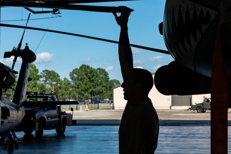 An Airman assigned to the 723d Aircraft Maintenance Squadron moves the rotor blade on an HH-60G Pave Hawk to make room for the aircraft in a hangar Aug. 30, 2019, at Moody Air Force Base, Ga. All Moody aircraft were hangared or secured in anticipation of Hurricane Dorian. (U.S. Air Force photo by Airman 1st Class Hayden Legg)