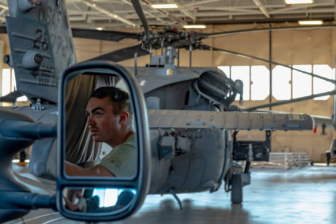 An Airman assigned to the 723d Aircraft Maintenance Squadron operates a tow truck pushing an HH-60G Pave Hawk into a hangar Aug. 30, 2019, at Moody Air Force Base, Ga. All Moody aircraft were hangared or secured in anticipation of Hurricane Dorian. (U.S. Air Force photo by Airman 1st Class Hayden Legg)