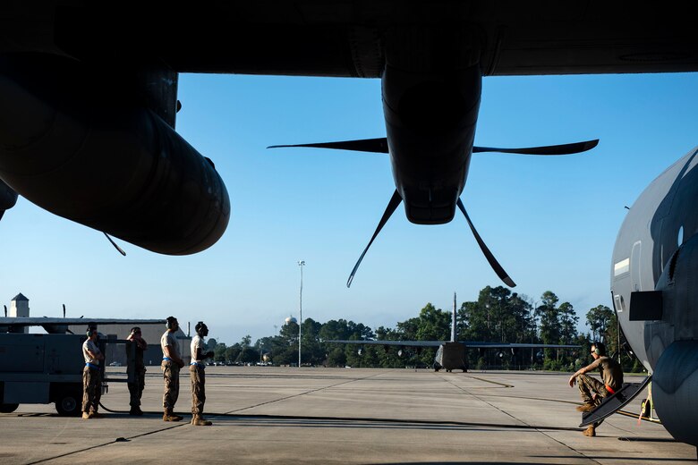 Airmen from the 71st Aircraft Maintenance Unit await the departure of an HC-130J Combat King II Aug. 30, 2019, at Moody Air Force Base (AFB), Ga. The aircraft was used to transport personnel and equipment to Little Rock AFB, Ark. in support of Hurricane Dorian aircraft relocation efforts. (U.S. Air Force photo by Senior Airman Erick Requadt)