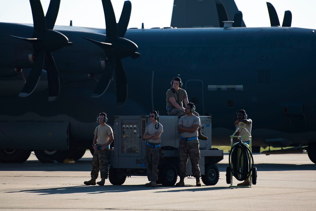 Airmen from the 71st Aircraft Maintenance Unit await the departure of an HC-130J Combat King II Aug. 30, 2019, at Moody Air Force Base (AFB), Ga. The aircraft was used to transport personnel and equipment to Little Rock AFB, Ark. in support of Hurricane Dorian aircraft relocation efforts. (U.S. Air Force photo by Senior Airman Erick Requadt)