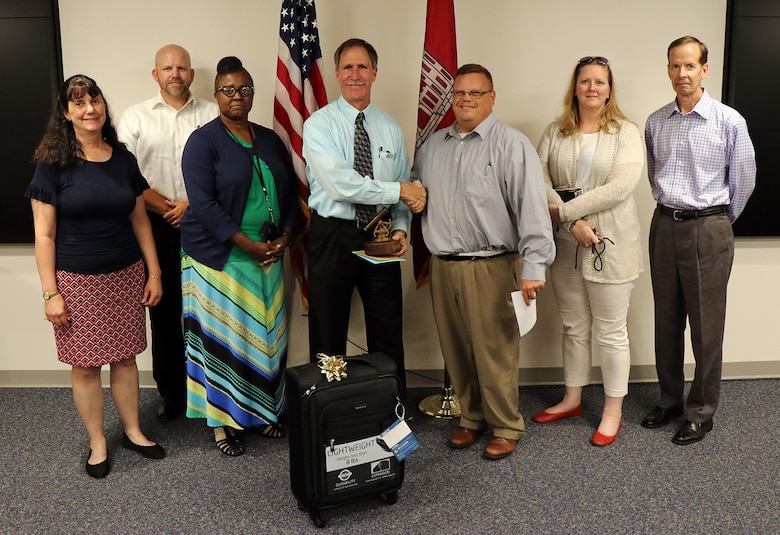 Members of the Transatlantic Division’s Programs Integration Division present gifts to Ronald J. Tomechko during his retirement ceremony on Aug. 29, 2019, at TAD’s headquarters in Winchester, Virginia. Tomechko was a program manager for the U.S. Army Corps of Engineers for more than three decades. (Photo by Erick Barnes, TAD Public Affairs)