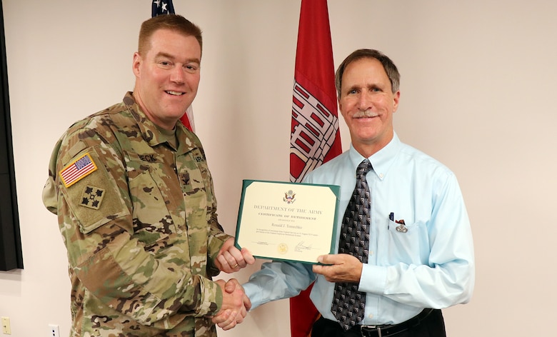 Transatlantic Division Commander Col. Christopher Beck presents the Department of the Army Superior Civilian Service Medal to Ronald J. Tomechko for his years of dedicated service to USACE and the American public. The medal was presented during Tomechko’s retirement ceremony on Aug. 29, 2019, at TAD’s headquarters in Winchester, Virginia.