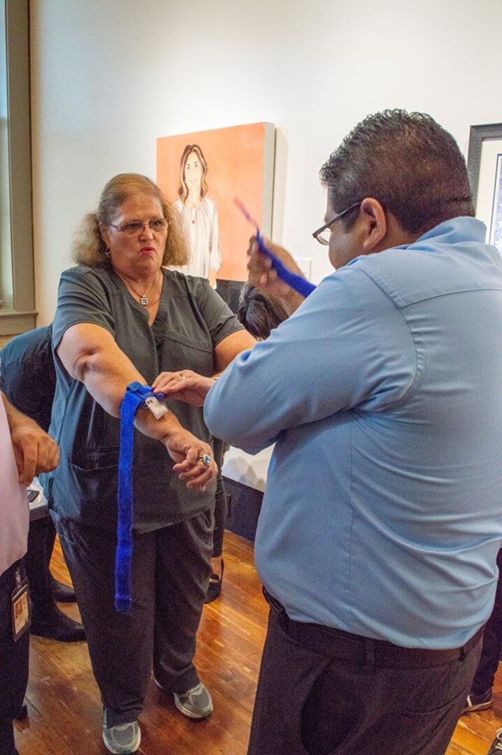 Sherrilee Demmer, educator for trauma services at Brooke Army Medical Center’s Trauma Clinic, shows City of San Antonio council staff members how to apply a tourniquet during Stop the Bleed held at the Plaza de Armas building in San Antonio Aug. 29. The training consisted of a presentation where attendees learned the “ABCs of Bleeding Control” along with some hands-on practice in applying tourniquets, packing wounds and applying direct pressure to stop bleeding.