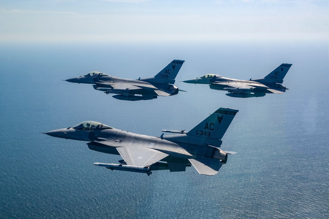 A picture of three 177th Fighter Wing F-16C and D Fighting Falcons flying over the Atlantic Ocean.