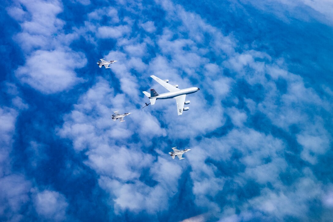 A picture of a KC-135 Stratotanker military refueling aircraft from the 108th Wing and three 177th Fighter Wing F-16C Fighting Falcons.