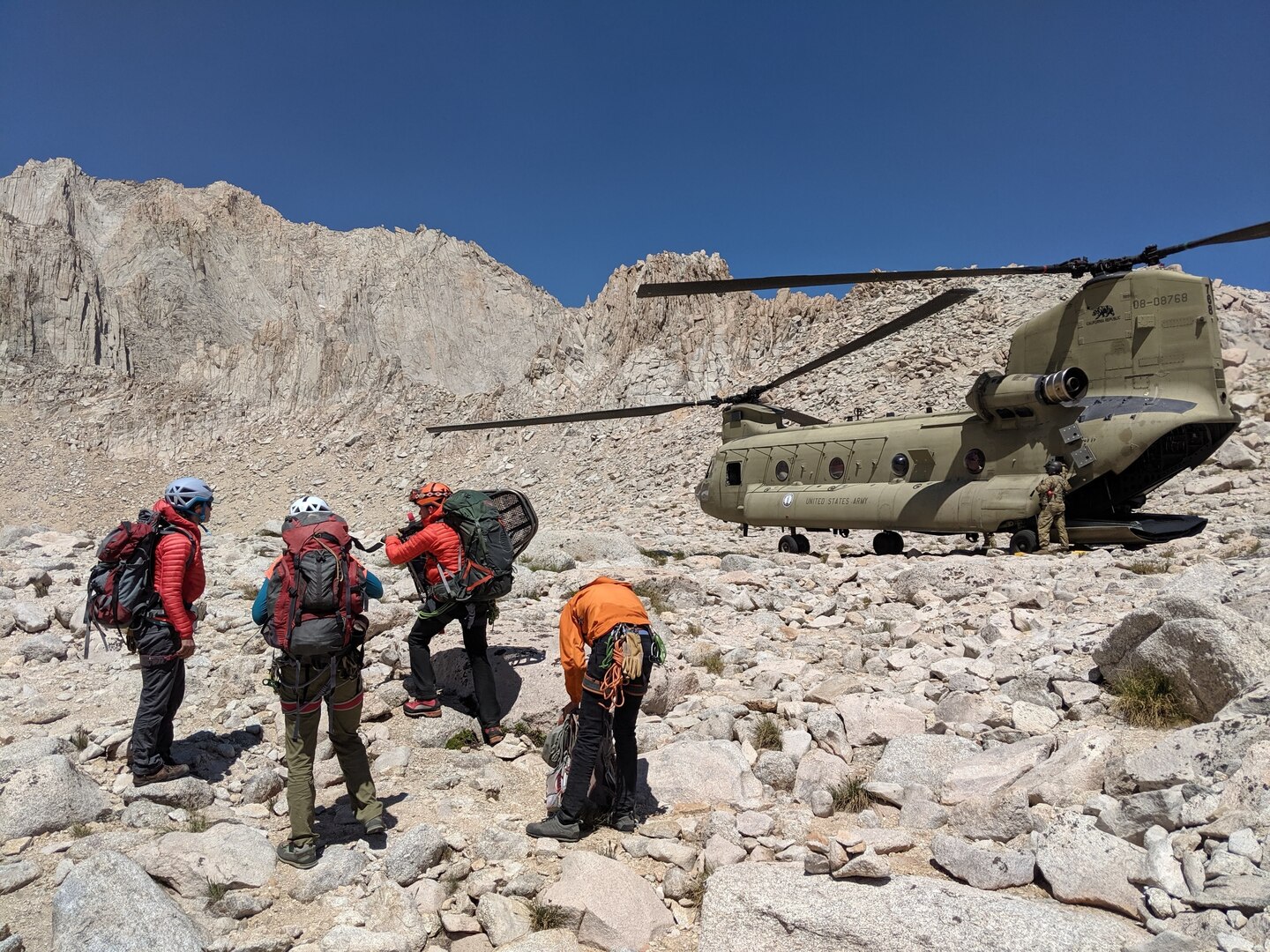 A team from Inyo County Search and Rescue is inserted near Iceberg Lake on Mount Whitney, Aug. 25, 2019, by a U.S. Army CH-47F Chinook helicopter assigned to B Company, 1st Battalion, 126th Aviation Regiment, California Army National Guard, for a high-altitude hoist rescue of an injured hiker about 700 feet below the mountain's peak. Cal Guard assists local, state and federal agencies during search and rescue missions and domestic disaster response efforts.