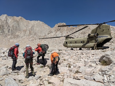 A team from Inyo County Search and Rescue is inserted near Iceberg Lake on Mount Whitney, Aug. 25, 2019, by a U.S. Army CH-47F Chinook helicopter assigned to B Company, 1st Battalion, 126th Aviation Regiment, California Army National Guard, for a high-altitude hoist rescue of an injured hiker about 700 feet below the mountain's peak. Cal Guard assists local, state and federal agencies during search and rescue missions and domestic disaster response efforts.