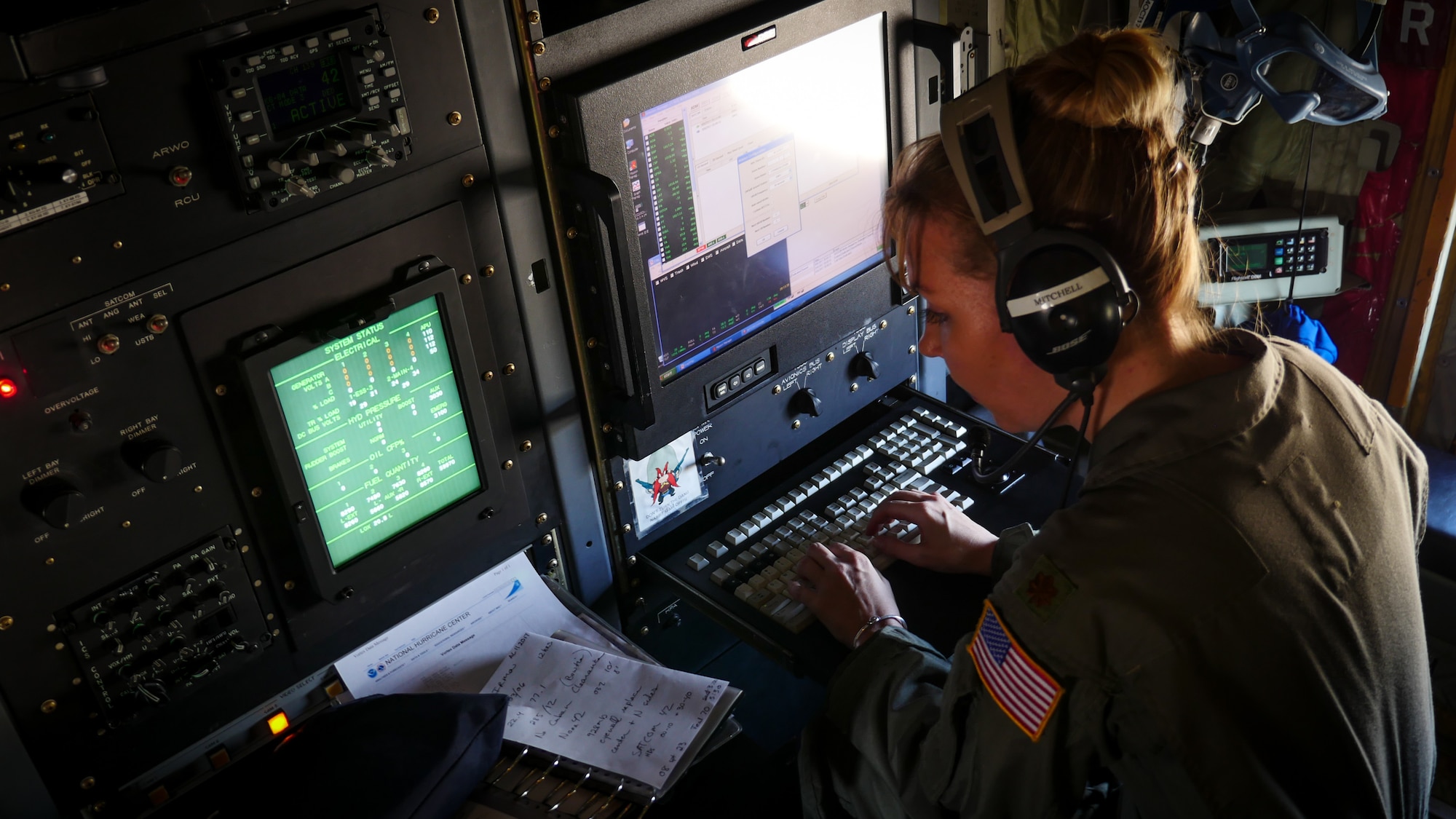 Air Force Reserve Maj. Nicole Mitchell, aerial reconnaissance weather officer, 53rd Weather Reconnaissance Squadron, Keesler Air Force Base, Mississippi, records weather information while flying into Hurricane Irma, Sep. 8, 2017. The Air Force Reserve 53rd Weather Reconnaissance Squadron "Hurricane Hunters" fly WC-130J Super Hercules though the eye of active hurricanes to collect weather data using aircraft and externally dropped sensors to provide accurate weather data to the National Hurricane Center on approaching hurricanes. The Reserve Citizen Airmen provide 100 percent of the Air Force capability in low-level, real time data collection in Atlantic and Pacific Ocean tropical weather systems. (U.S. Air Force photo by Staff Sgt. Corban Lundborg)