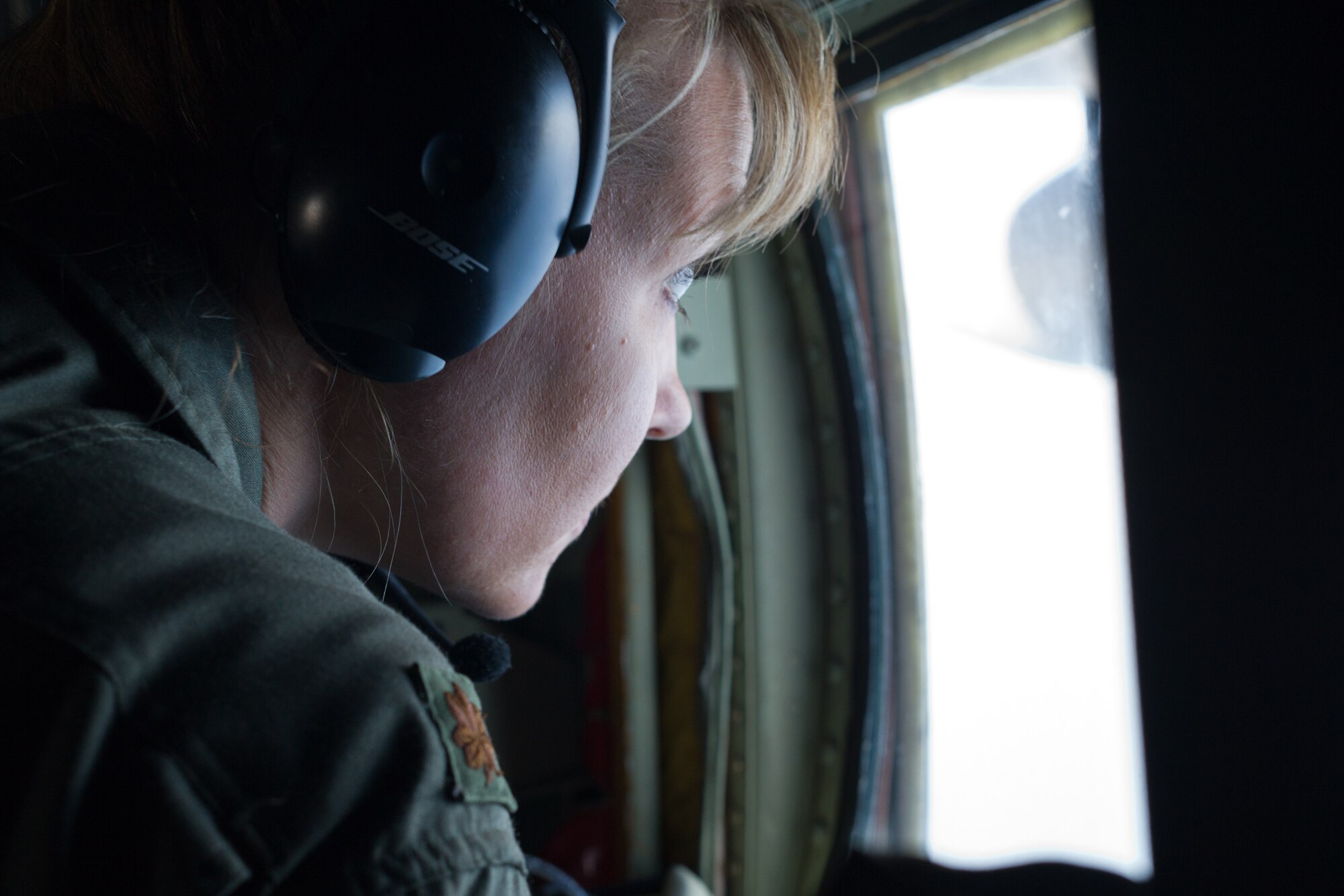 Air Force Reserve Maj. Nicole Mitchell, aerial reconnaissance weather officer, 53rd Weather Reconnaissance Squadron, Keesler Air Force Base, Mississippi, looks out her observation window while flying into Hurricane Irma Sep. 8, 2017. The Air Force Reserve 53rd Weather Reconnaissance Squadron "Hurricane Hunters" fly WC-130J Super Hercules though the eye of active hurricanes to collect weather data using aircraft and externally dropped sensors to  provide accurate weather data to the National Hurricane Center on approaching hurricanes. The Reserve Citizen Airmen provide 100 percent of the Air Force capability in low-level, real time data collection in Atlantic and Pacific Ocean tropical weather systems. (U.S. Air Force photo by Staff Kyle Brasier)